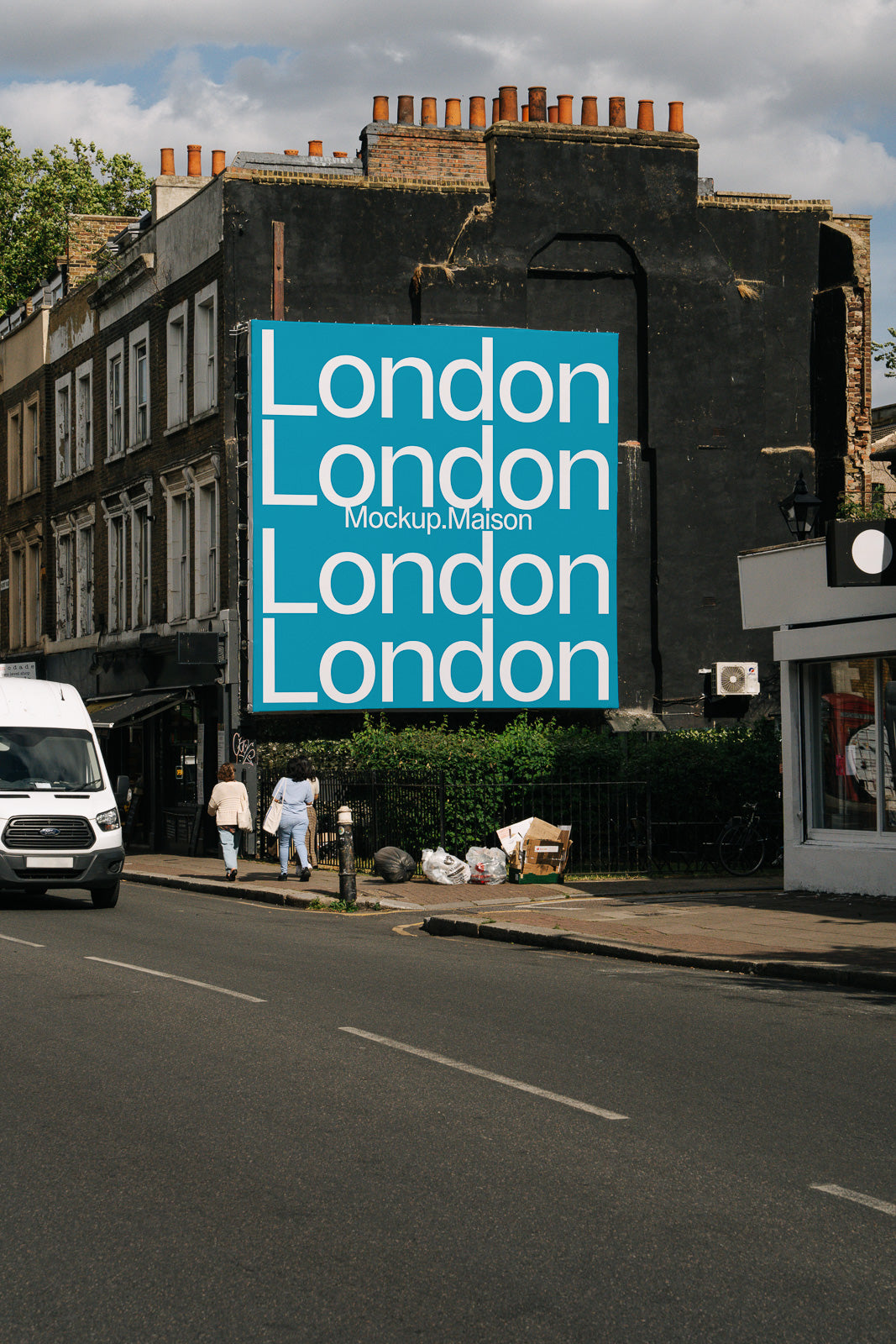 PSD mockup of a large billboard on an urban street with the word "London" repeated in white text over a blue background, placed on a black building.