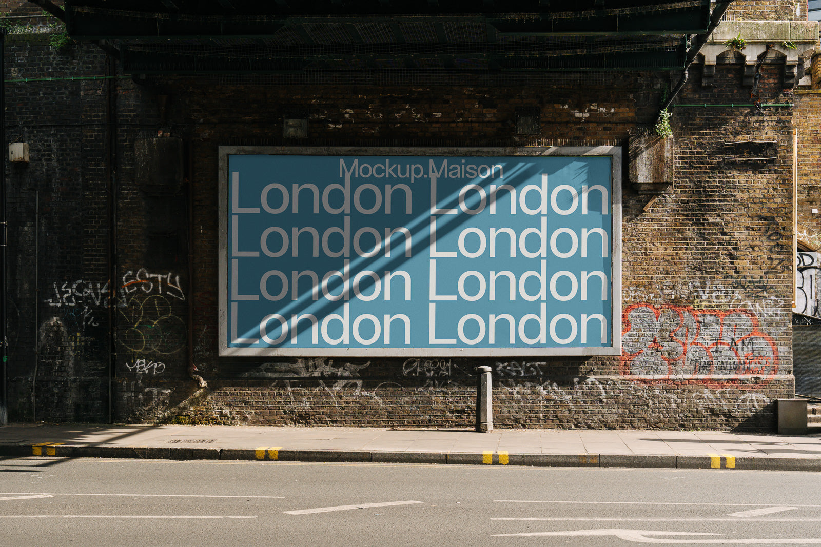 PSD mockup of a large billboard under a railway bridge in an urban setting, with the word "London" repeated in bold white text on a blue background.