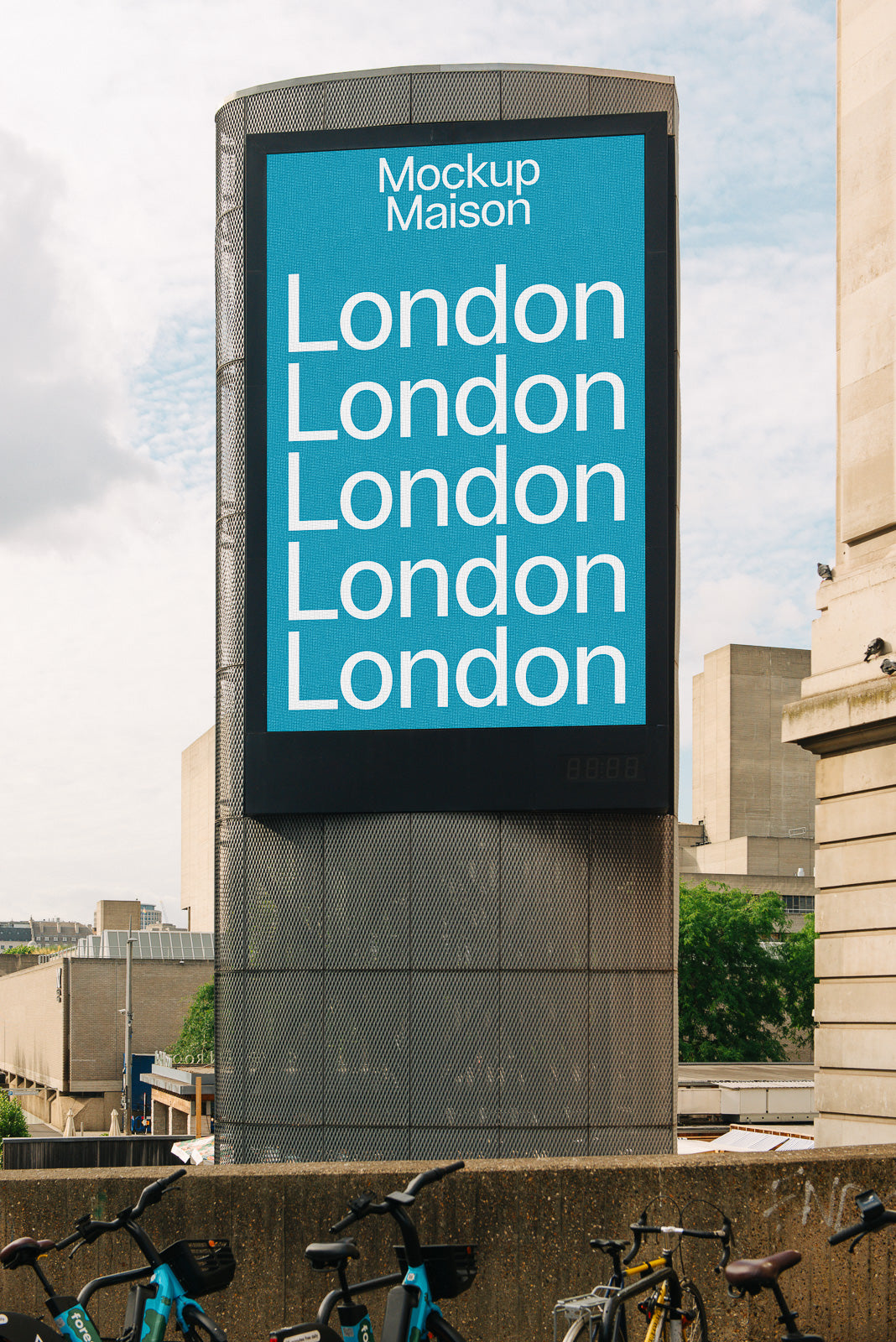 PSD mockup of a tall building billboard displaying the word "London" multiple times on a blue background, with a cityscape in the background.
