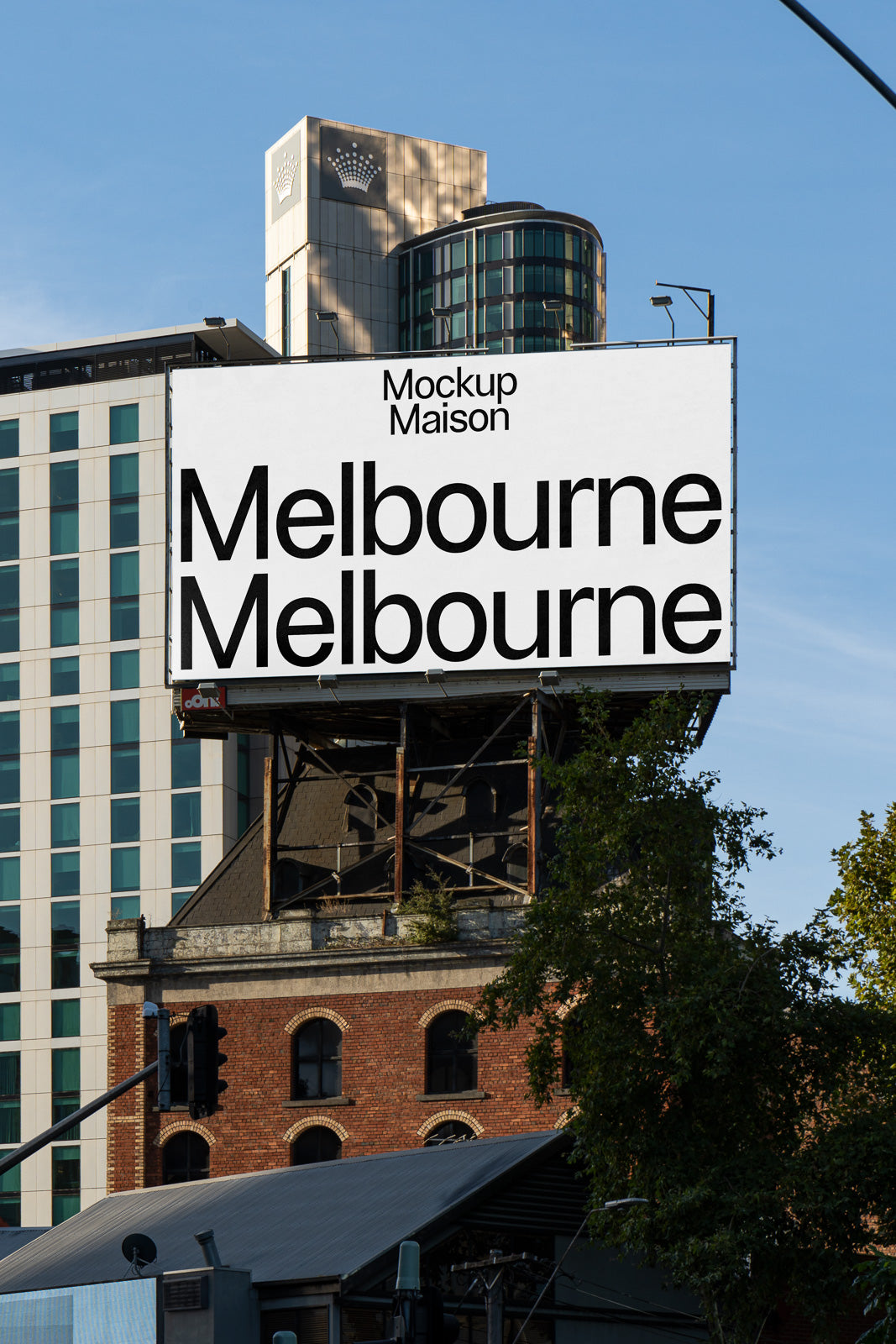 PSD mockup of a billboard displaying the text "Mockup Maison Melbourne" against a city backdrop with modern buildings and clear blue sky.