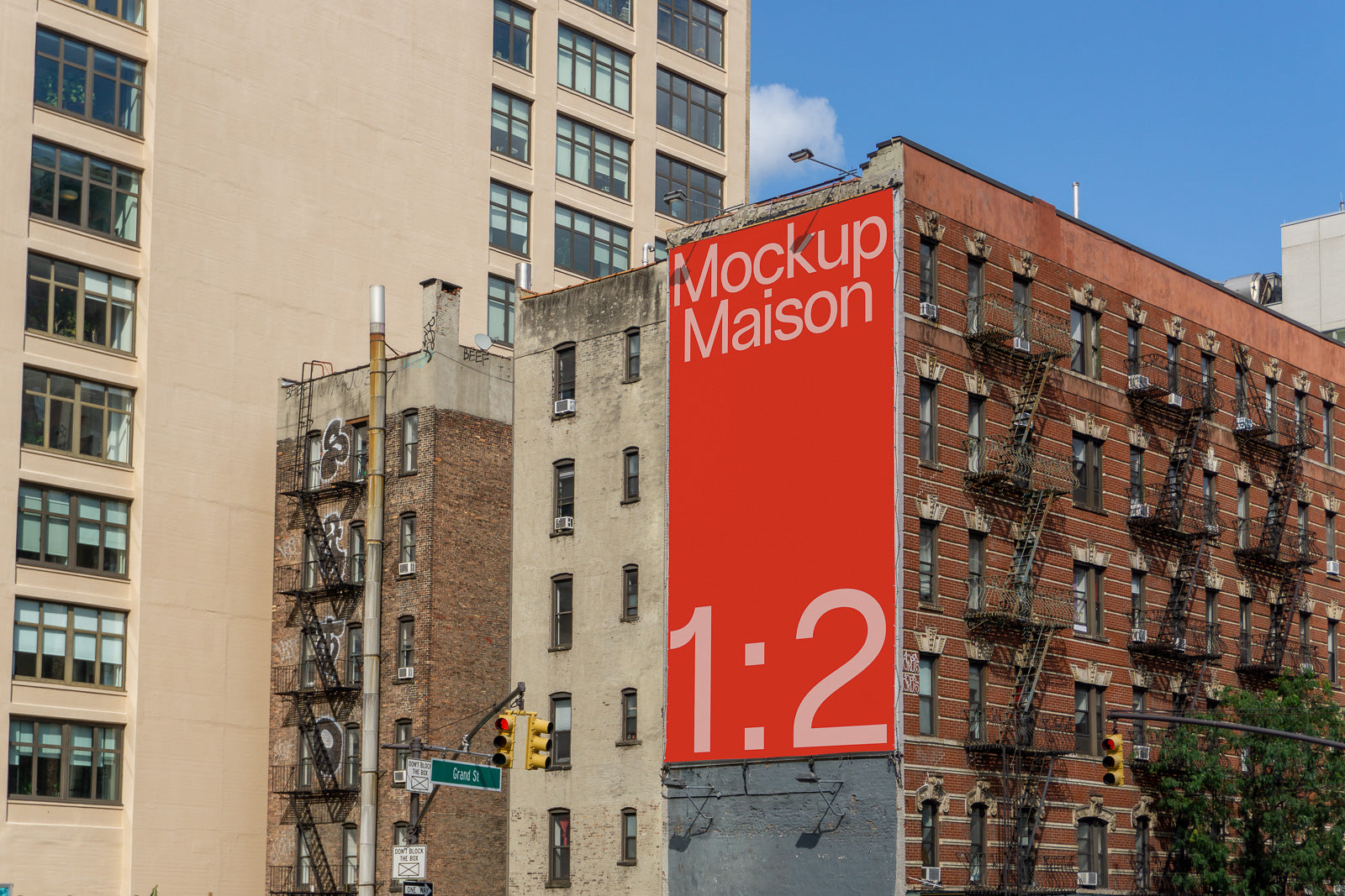 PSD mockup of a red outdoor billboard on an urban building with "Mockup Maison 1:2" text, surrounding brick architecture, and a street intersection.