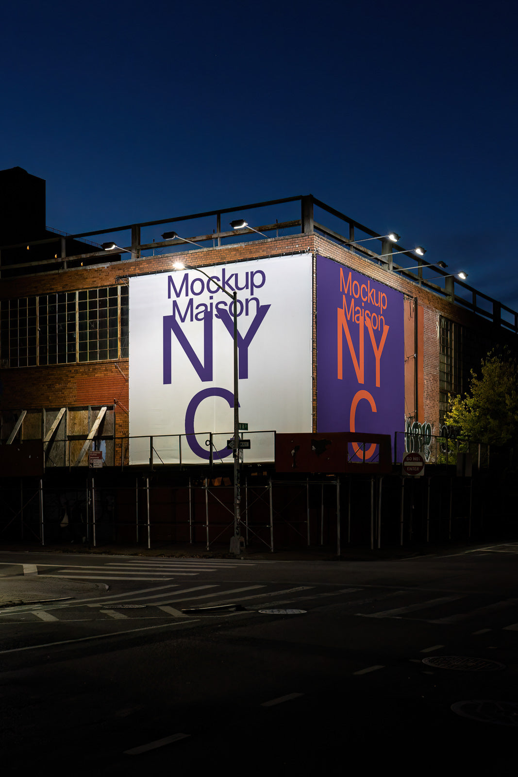 PSD mockup of a building facade at night featuring large signs with "Mockup Maison NYC" text in bold, illuminated by overhead lights.