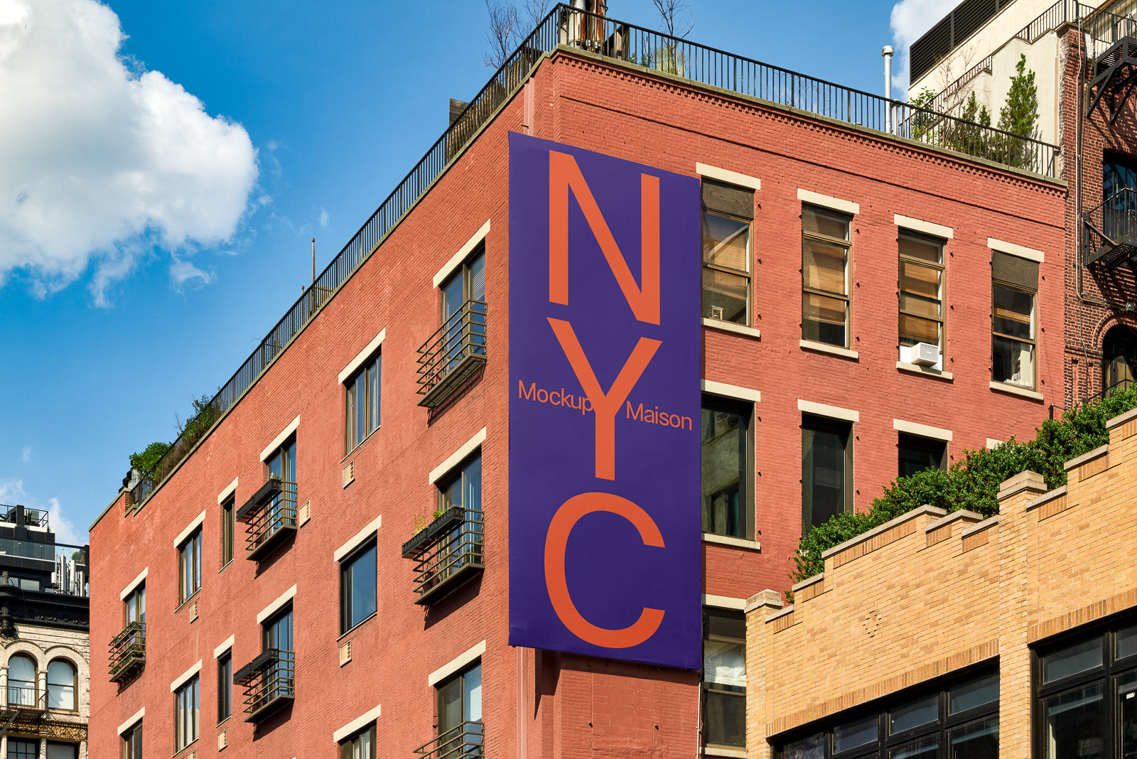 PSD mockup of a vibrant purple banner with "NYC" in bold orange letters hanging on a red brick building against a clear blue sky.