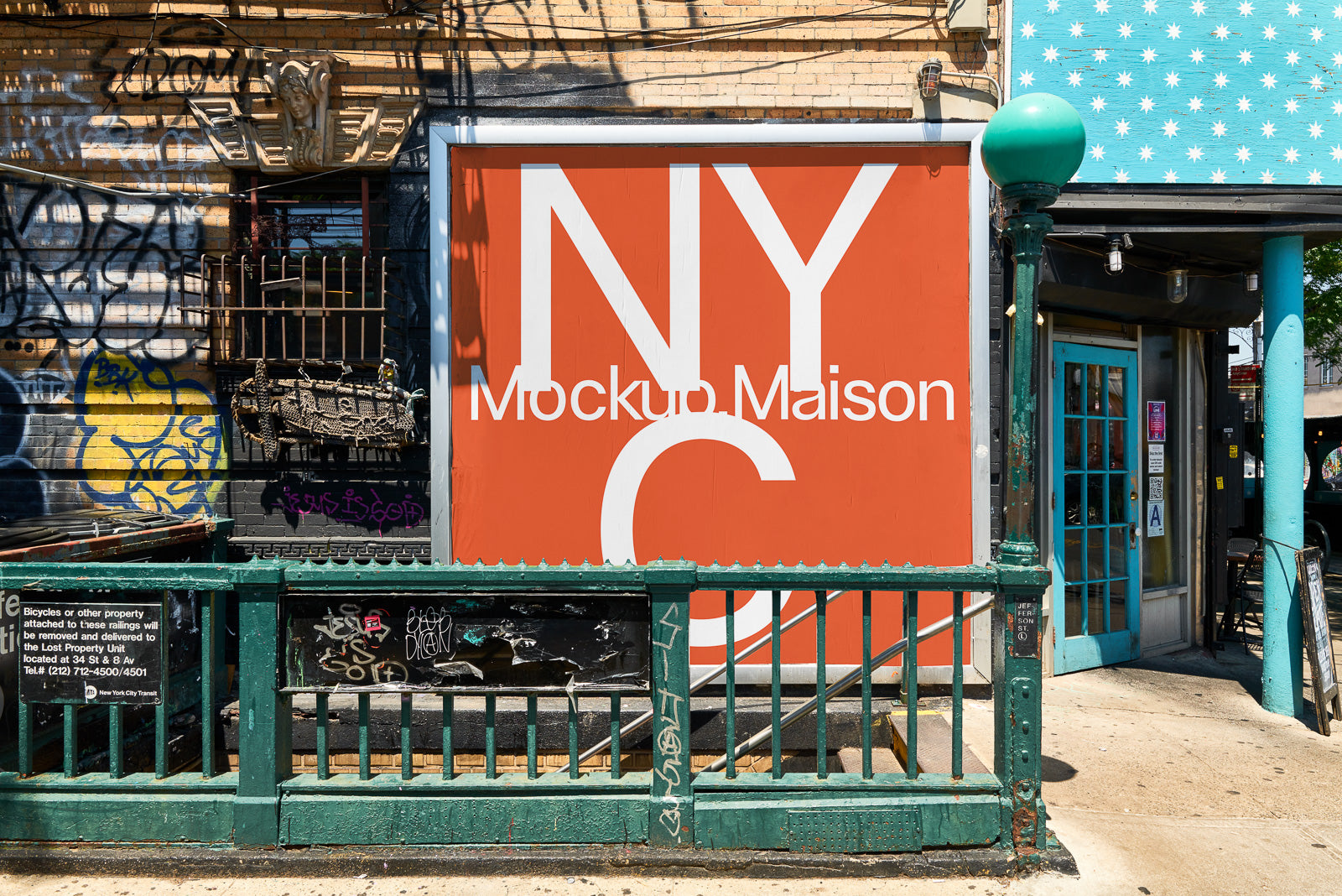 PSD mockup of a large, red outdoor billboard with the text "NYC Mockup Maison" next to urban graffiti and a green metal railing.