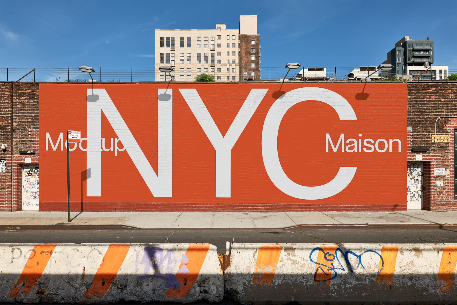 PSD mockup of a large billboard displaying "NYC Maison" in bold letters on an orange background, set against an urban street scene with buildings.