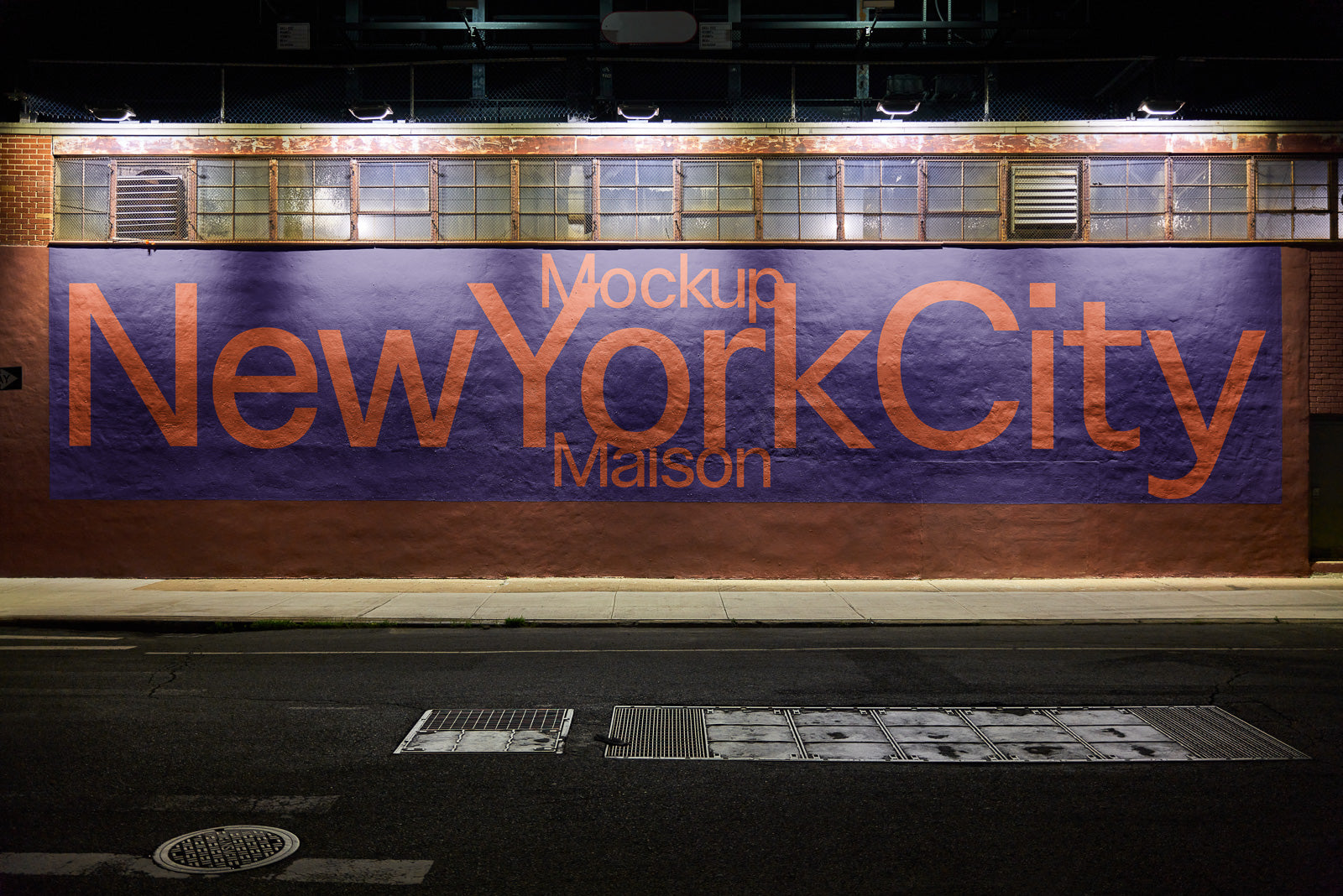 PSD mockup of a large building wall displaying "New York City" in bold letters, illuminated by streetlights at night.