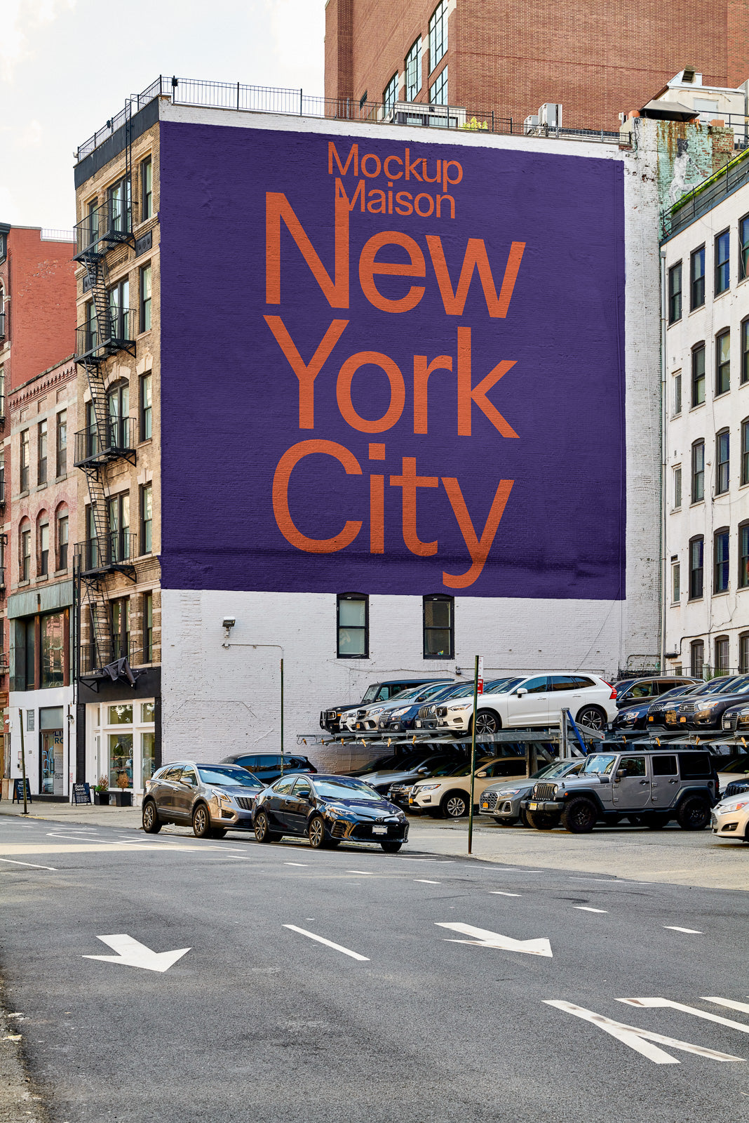 PSD mockup of a large purple billboard on an urban street corner, displaying bold orange text that reads "Mockup Maison New York City" above a parking lot.