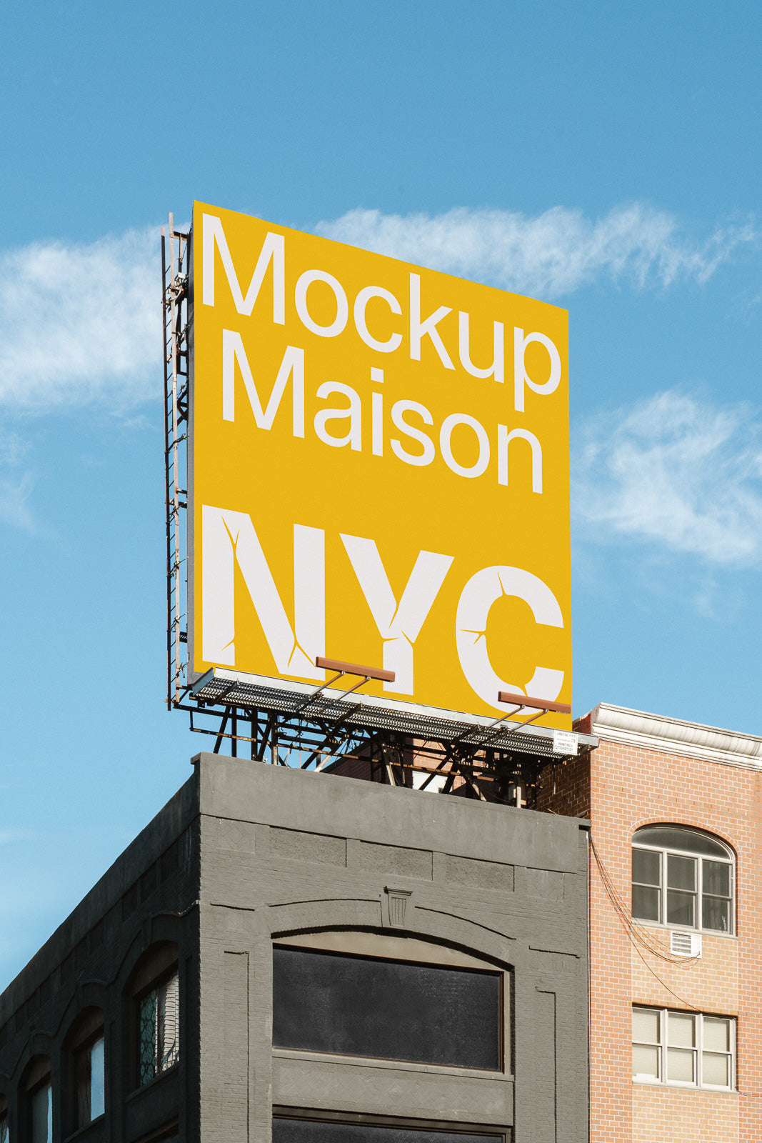 PSD mockup of a large yellow billboard displaying "Mockup Maison NYC" against a clear blue sky, mounted on a building's rooftop.