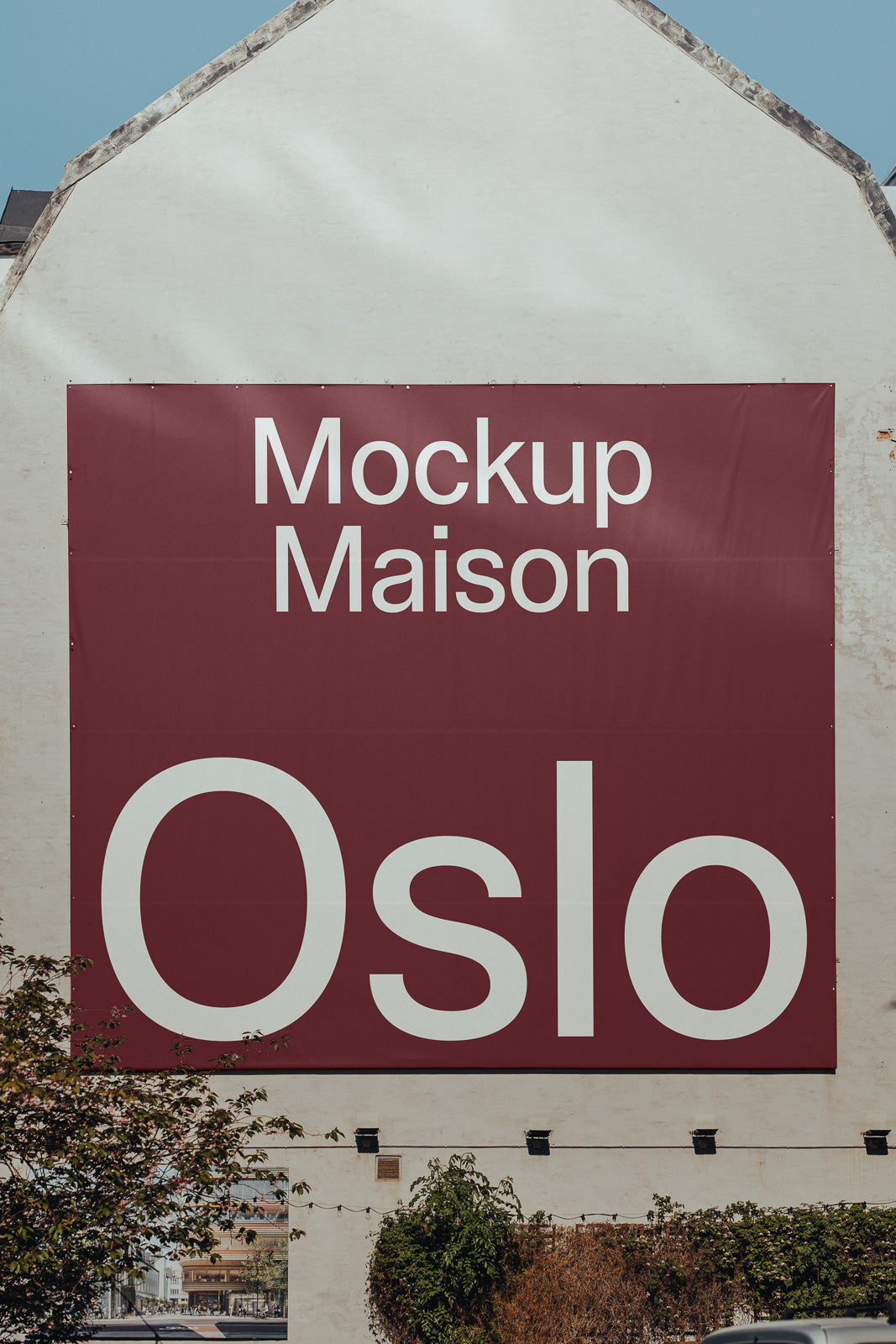 PSD mockup of a large, red banner on a building exterior featuring the text “Mockup Maison Oslo” in bold white letters.