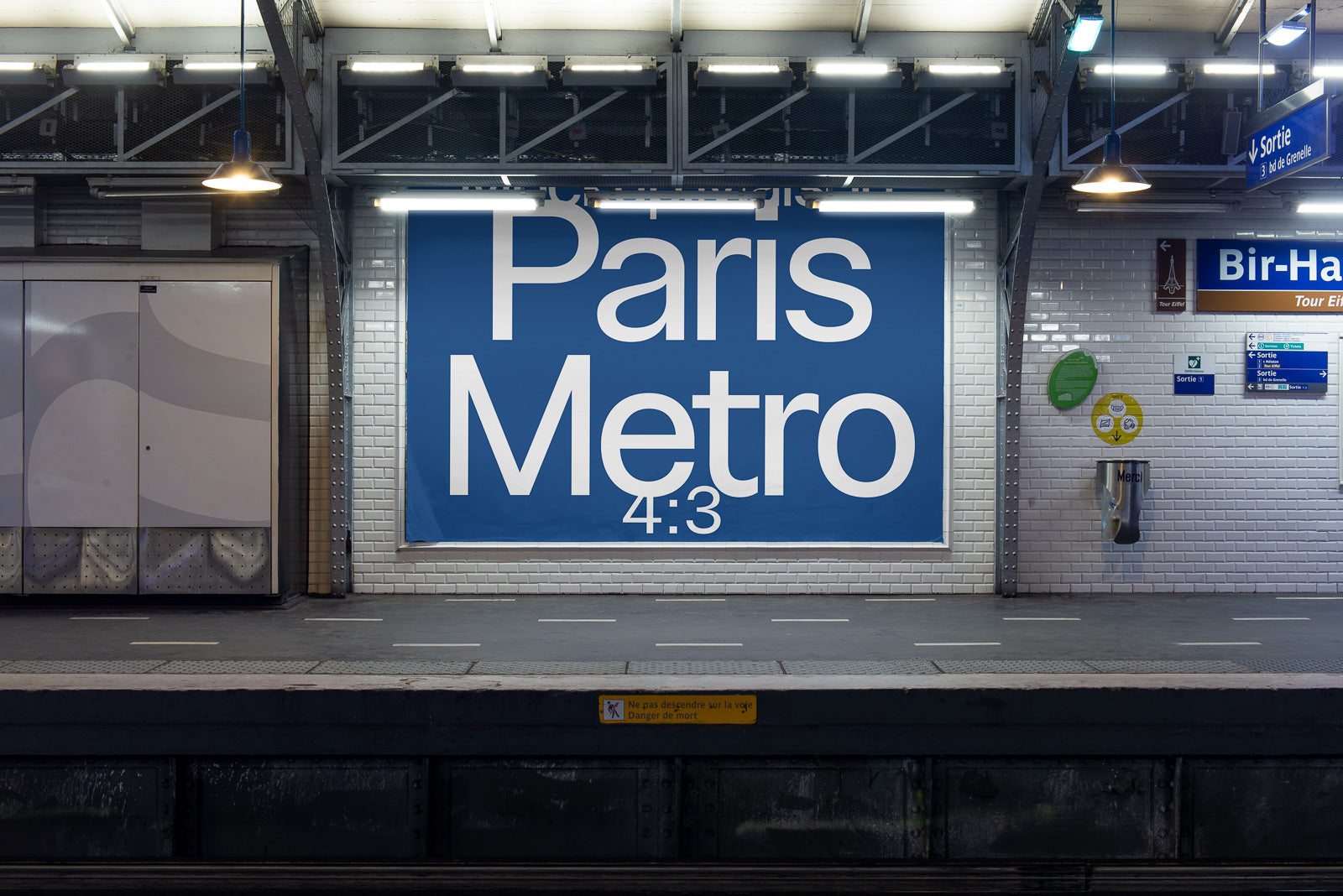 PSD mockup of a Paris Metro station platform featuring a large blue advertising banner with white text, illuminated under bright overhead lights.