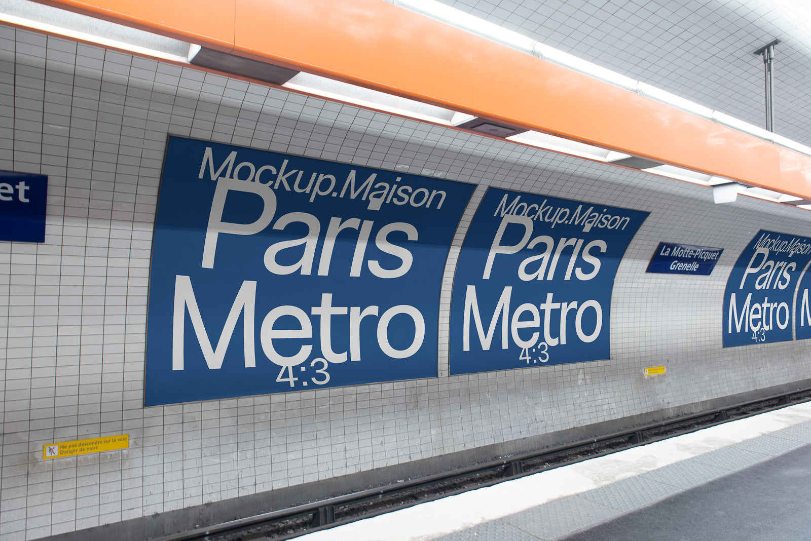 PSD mockup of Paris Metro station platform with large blue advertising panels, showcasing a clean tiled wall environment under an orange overhead structure.