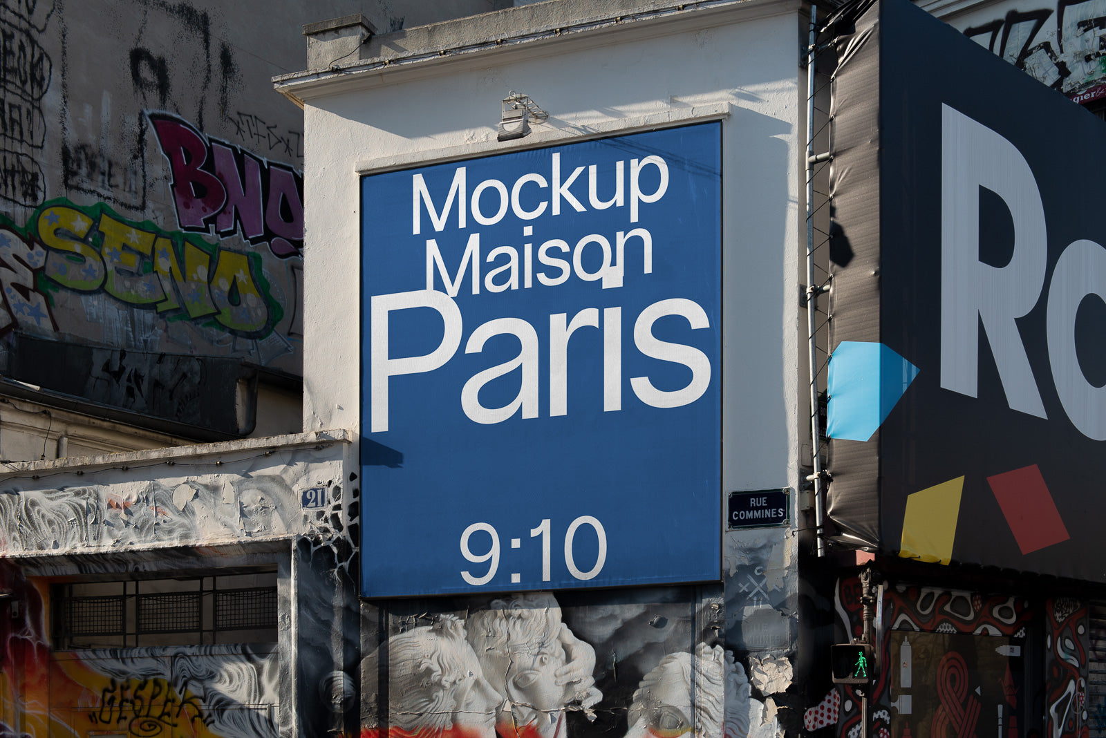 PSD mockup of a large blue sign with "Mockup Maison Paris 9:10" on a graffiti-covered building exterior in urban setting.