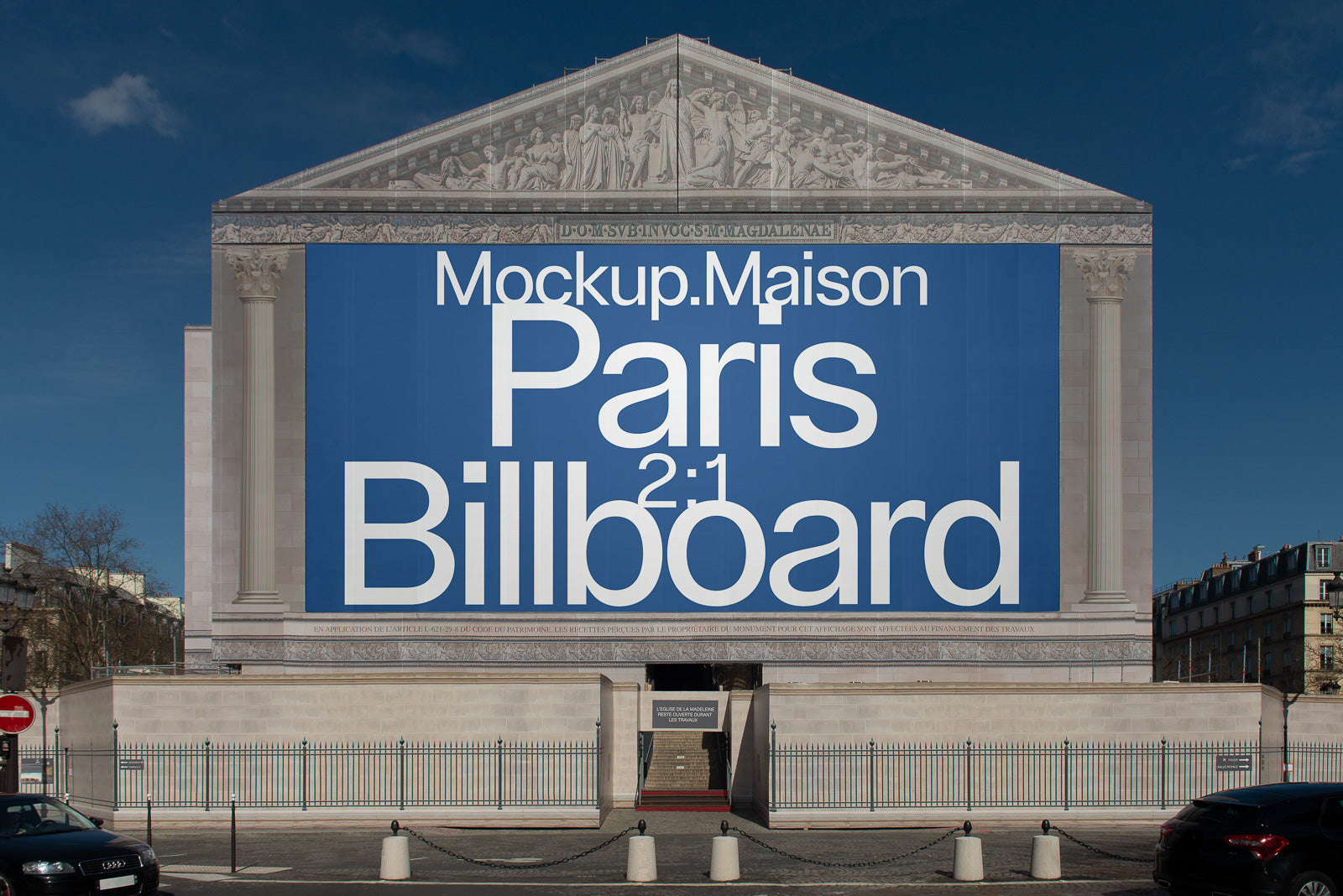 PSD mockup of a large billboard on a classic stone building façade with columns and detailed sculptures above, featuring bold text on a blue background.
