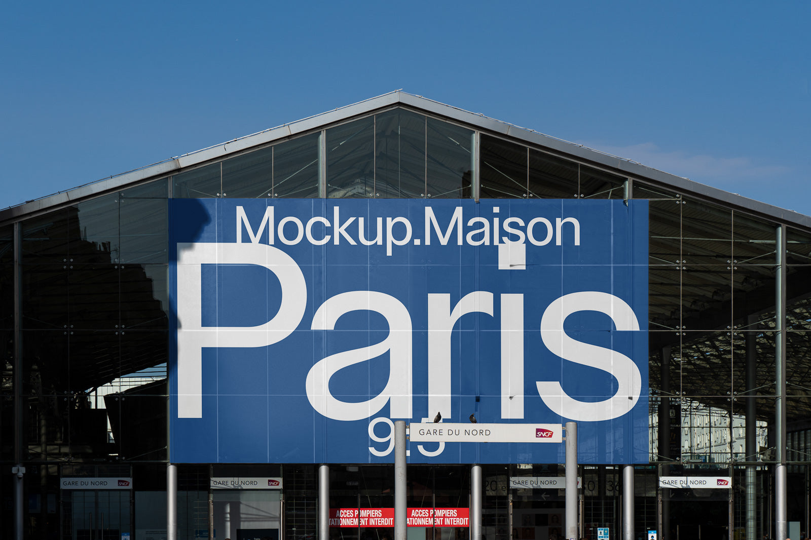 PSD mockup of a large blue billboard displaying the word "Paris" above the entrance of Gare du Nord, emphasizing its prominence.
