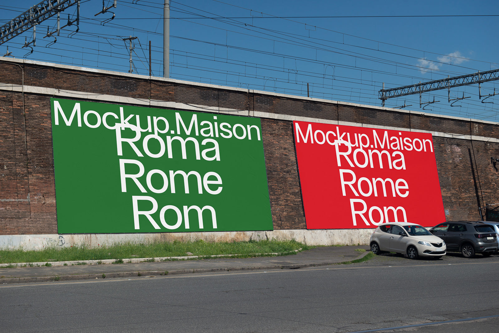 PSD mockup of two large posters on a brick wall alongside a road, featuring text on green and red backgrounds with parked cars below.
