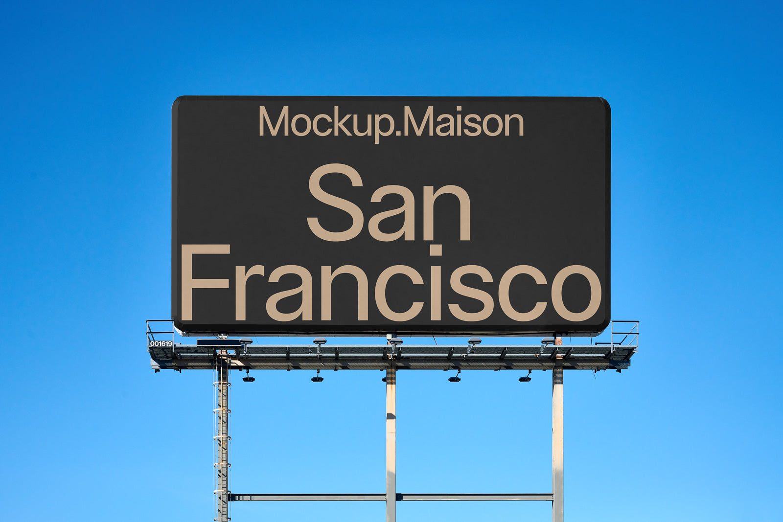PSD mockup of a large outdoor billboard against a clear blue sky, displaying the text "Mockup.Maison San Francisco" in bold letters.