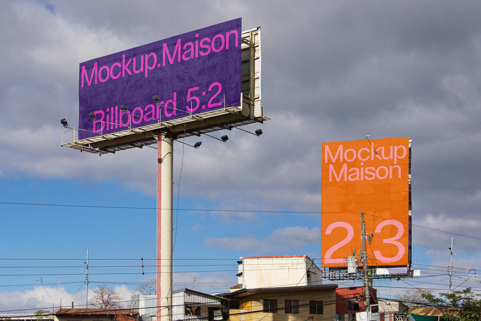PSD mockup of two large outdoor billboards in an urban setting, one with a purple background and the other orange, featuring sky and clouds in the background.