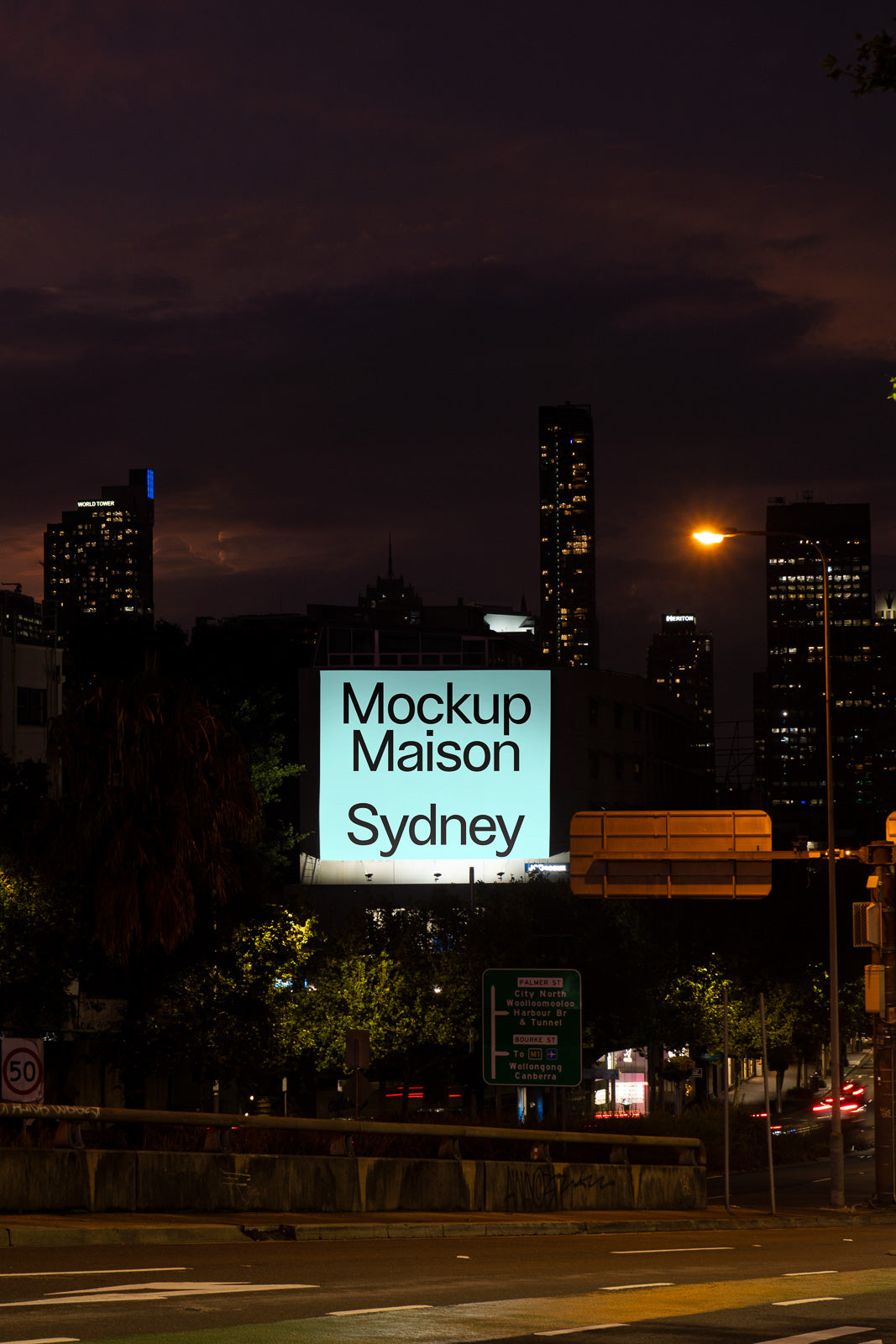 PSD mockup of a glowing billboard at night with cityscape background, featuring text "Mockup Maison Sydney" illuminated against urban skyline.