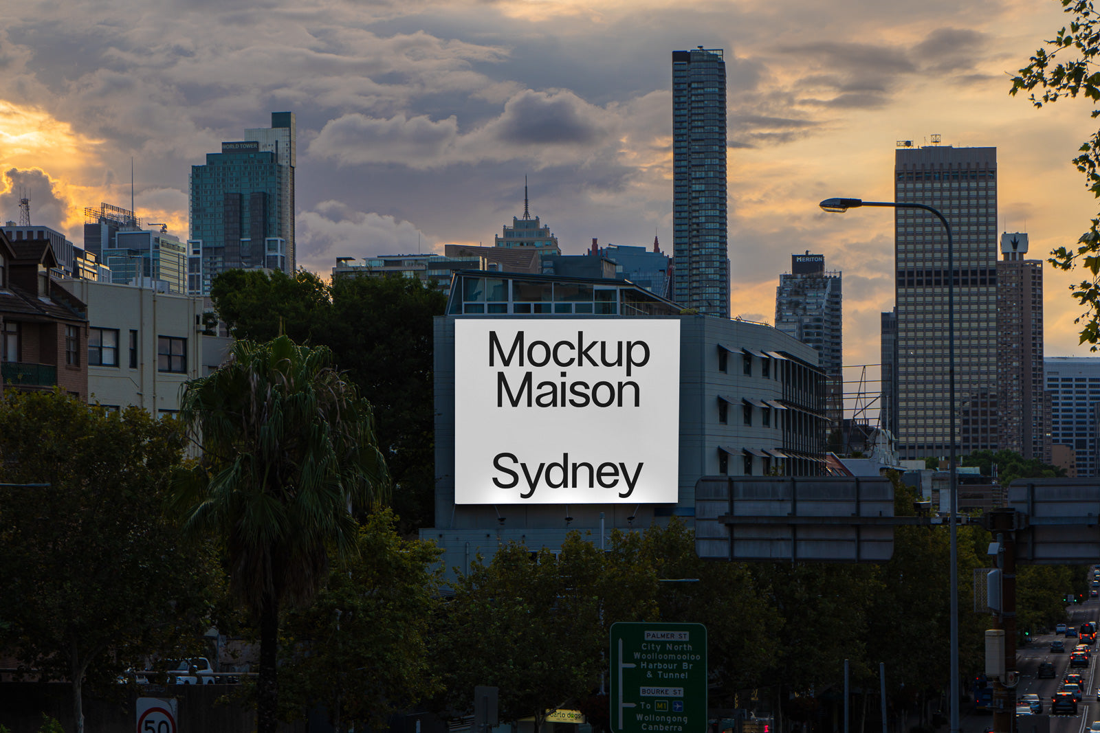 PSD mockup of a billboard on a city building at sunset, showcasing the text "Mockup Maison Sydney" against a backdrop of skyscrapers and cloudy sky.