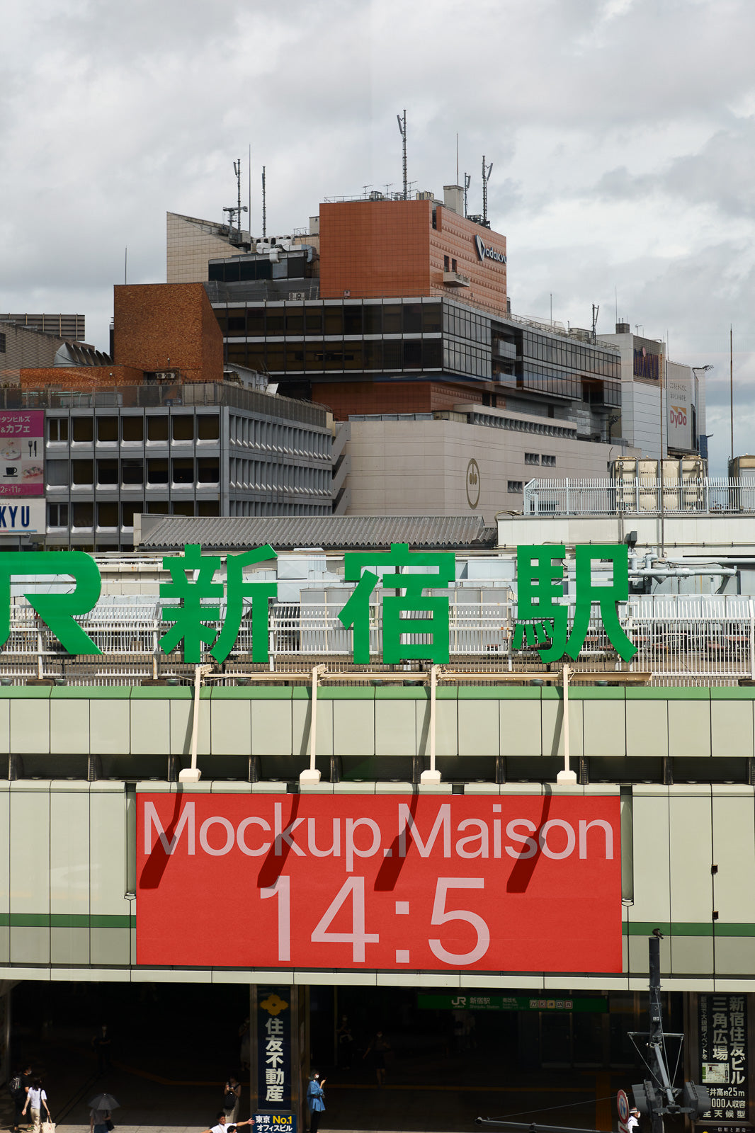 PSD mockup of an urban railway station with prominent green signage and a large red banner displaying "Mockup.Maison 14:5."