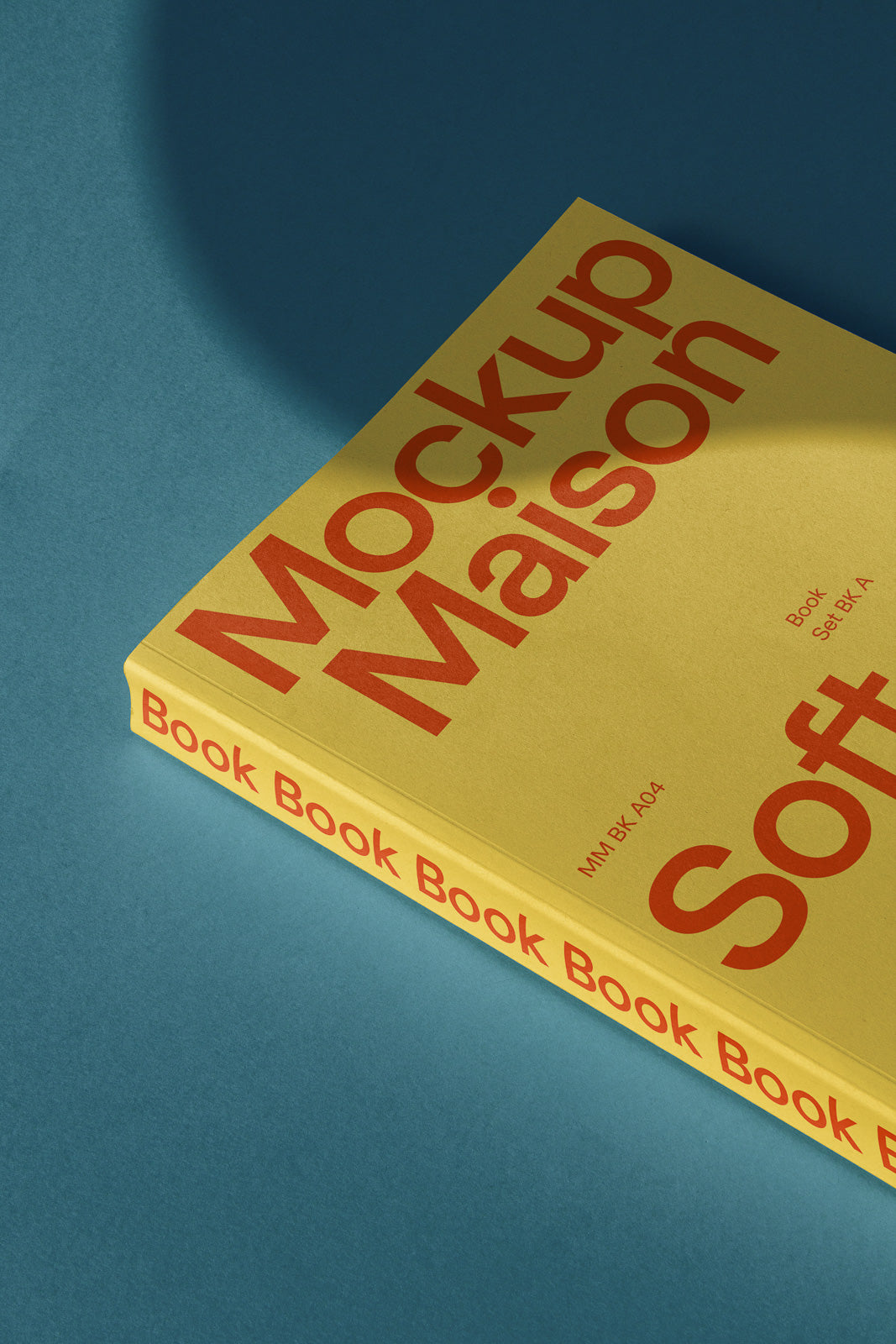PSD mockup of a yellow softcover book lying on a blue surface, featuring bold, red typography with a shadow effect adding depth.
