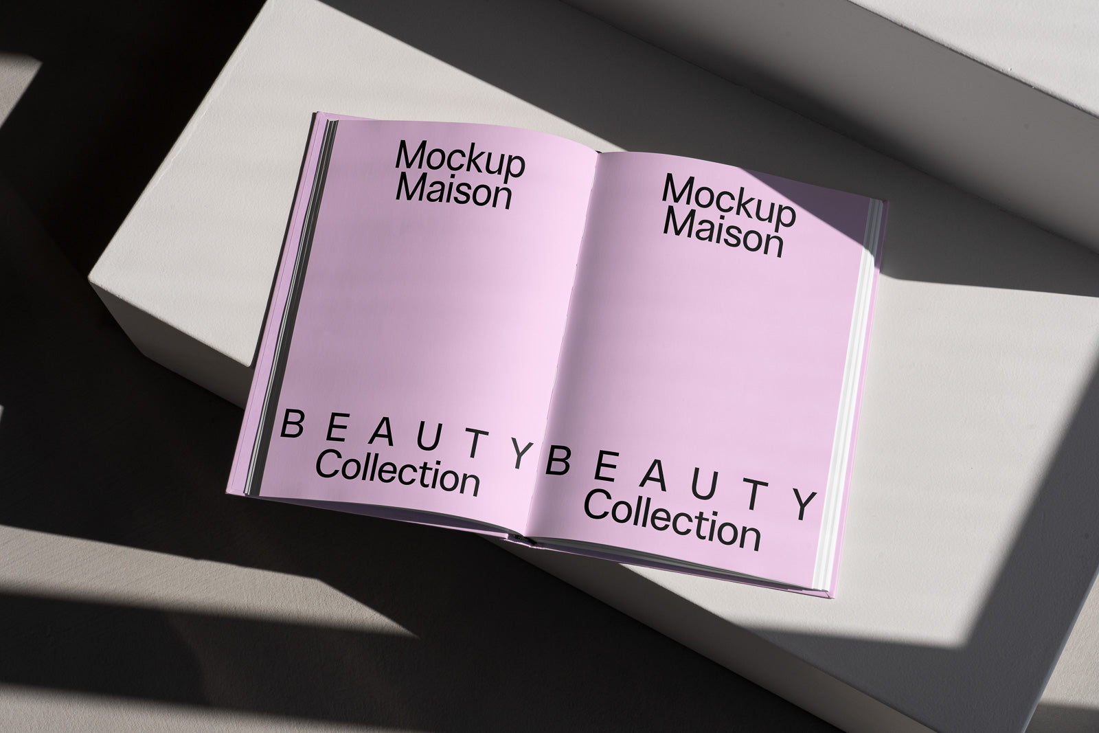 PSD mockup of an open book titled "Mockup Maison Beauty Collection" on a pink background, placed on a geometric white surface with shadow patterns.
