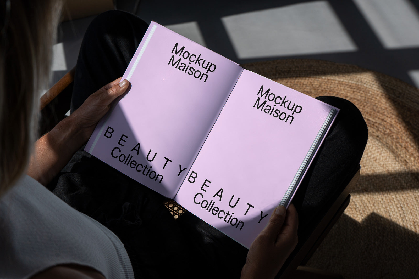 PSD mockup of an open book featuring "Mockup Maison" and "Beauty Collection" on a light purple background in a person's hands, reflecting natural light.