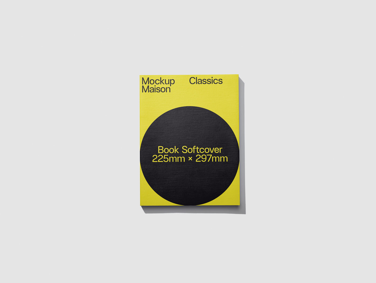 PSD mockup of a yellow book softcover with dimensions 225mm x 297mm, featuring a bold black circle and text, isolated on a light gray background.