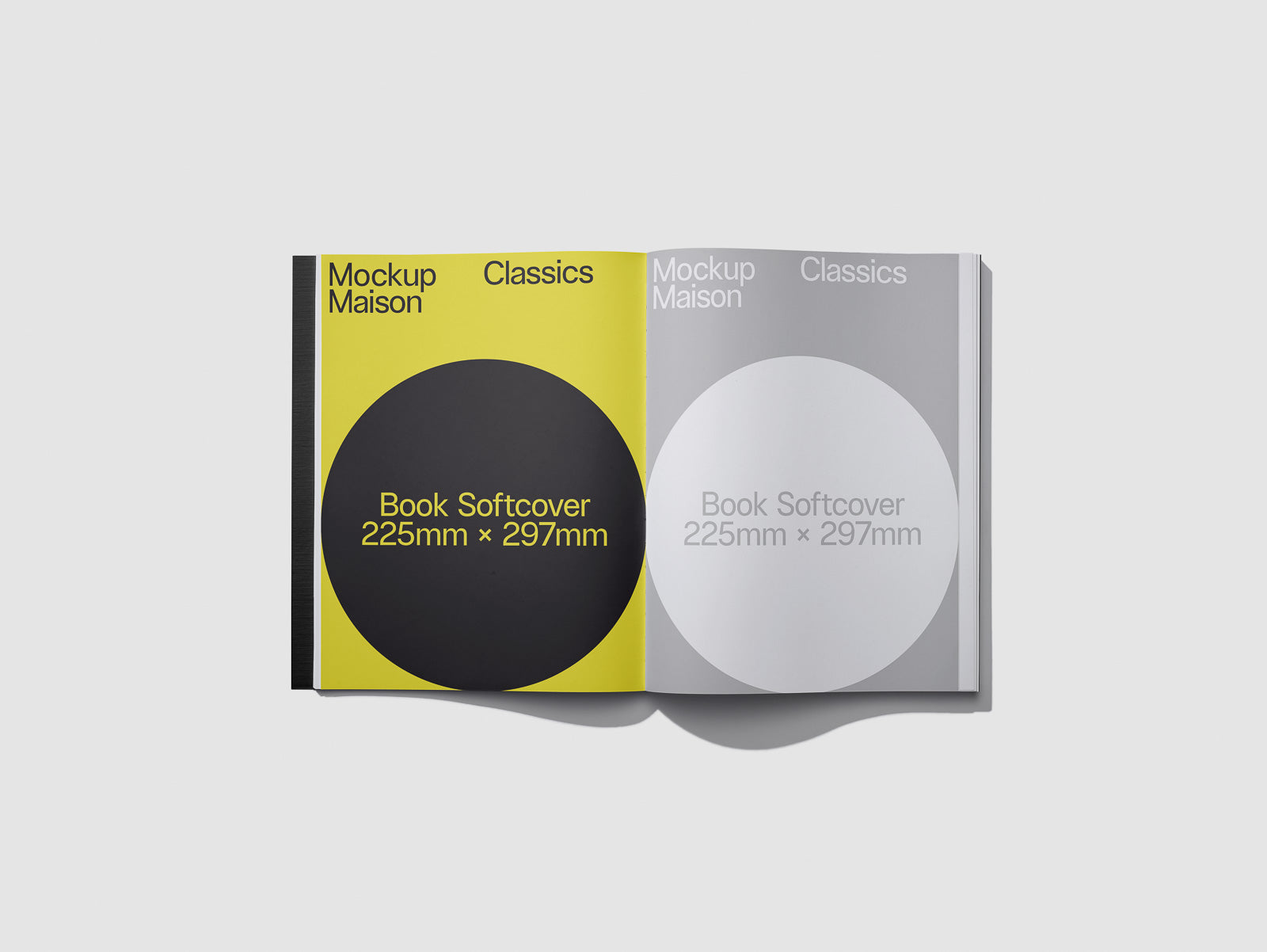 PSD mockup of an open softcover book with yellow and gray pages, displaying circular graphics and text indicating dimensions 225mm x 297mm.