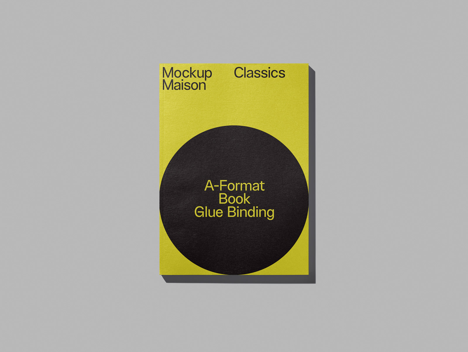 PSD mockup of a yellow book cover with a black circle, titled "A-Format Book Glue Binding," featuring text "Mockup Maison Classics" at the top.