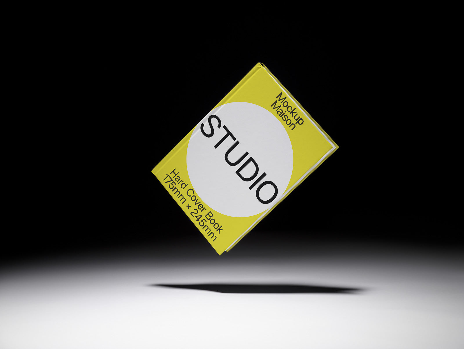 PSD mockup of a yellow hardcover book titled "STUDIO," featuring dimensions 175mm x 245mm, floating against a dark background.