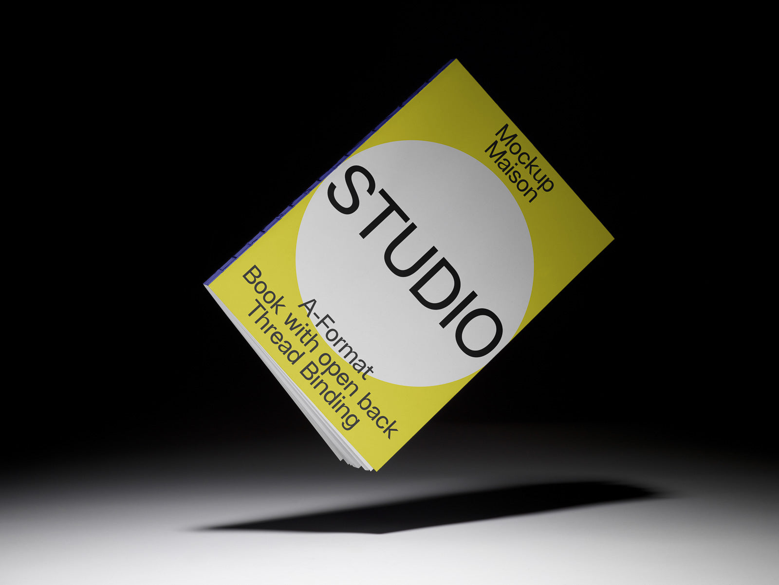 PSD mockup of a book with a yellow cover featuring the text "STUDIO" and "Mockup Maison" on a dark background.