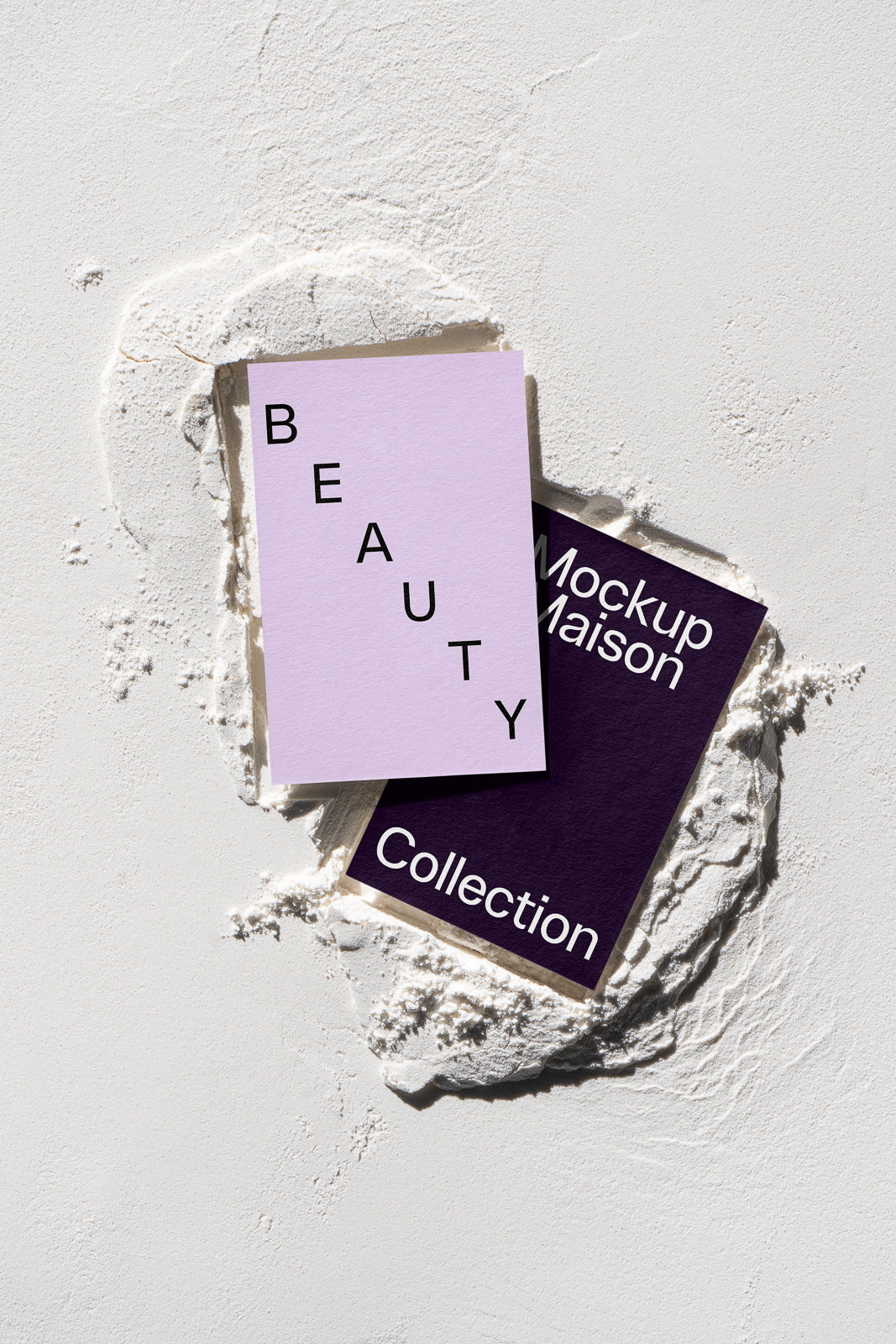 PSD mockup of two stacked cards in textured powder, one lavender with "BEAUTY" and the other dark purple with "Mockup Maison Collection".