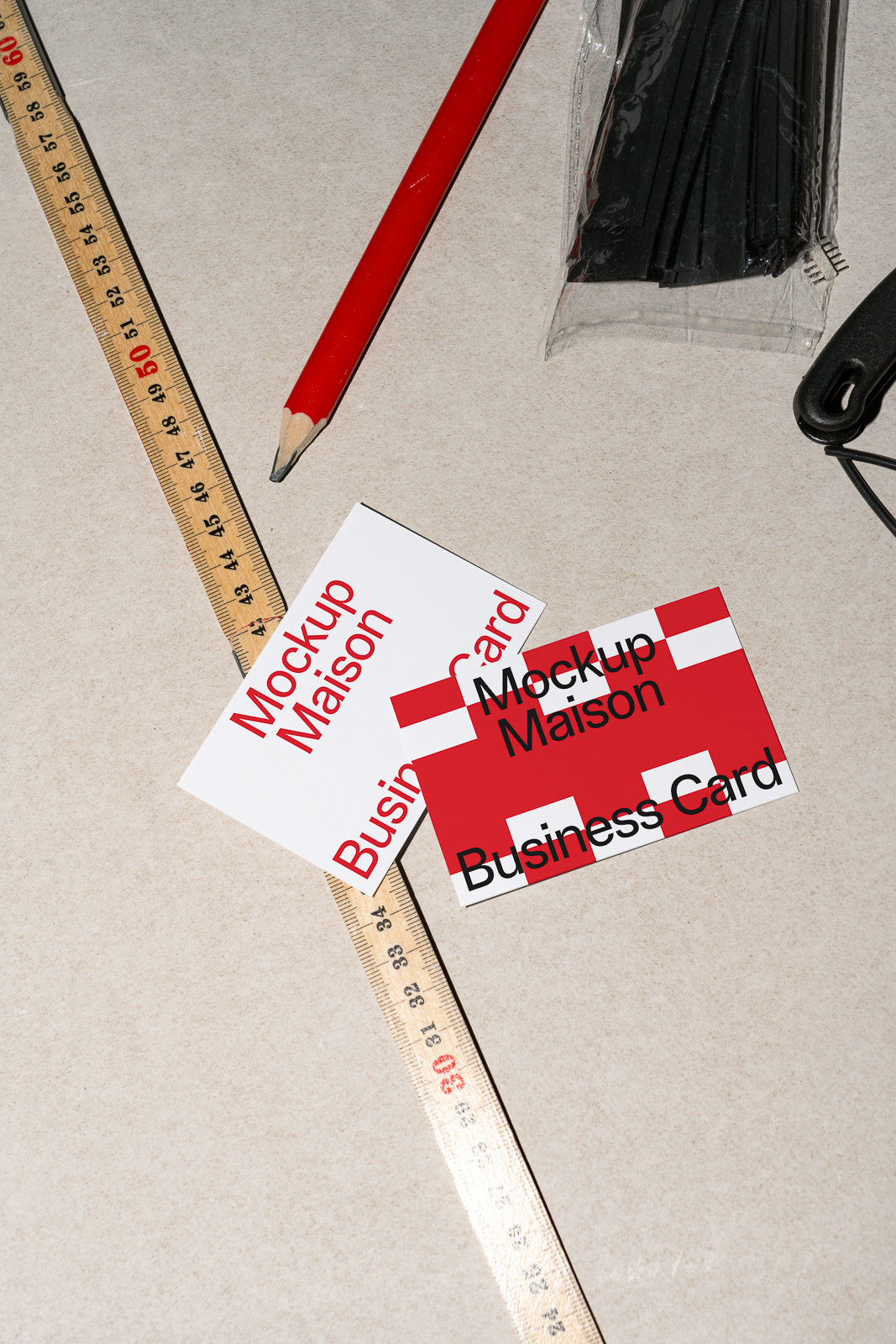 PSD mockup of business cards labeled "Mockup Maison" on a table with a red pencil and measuring ruler.