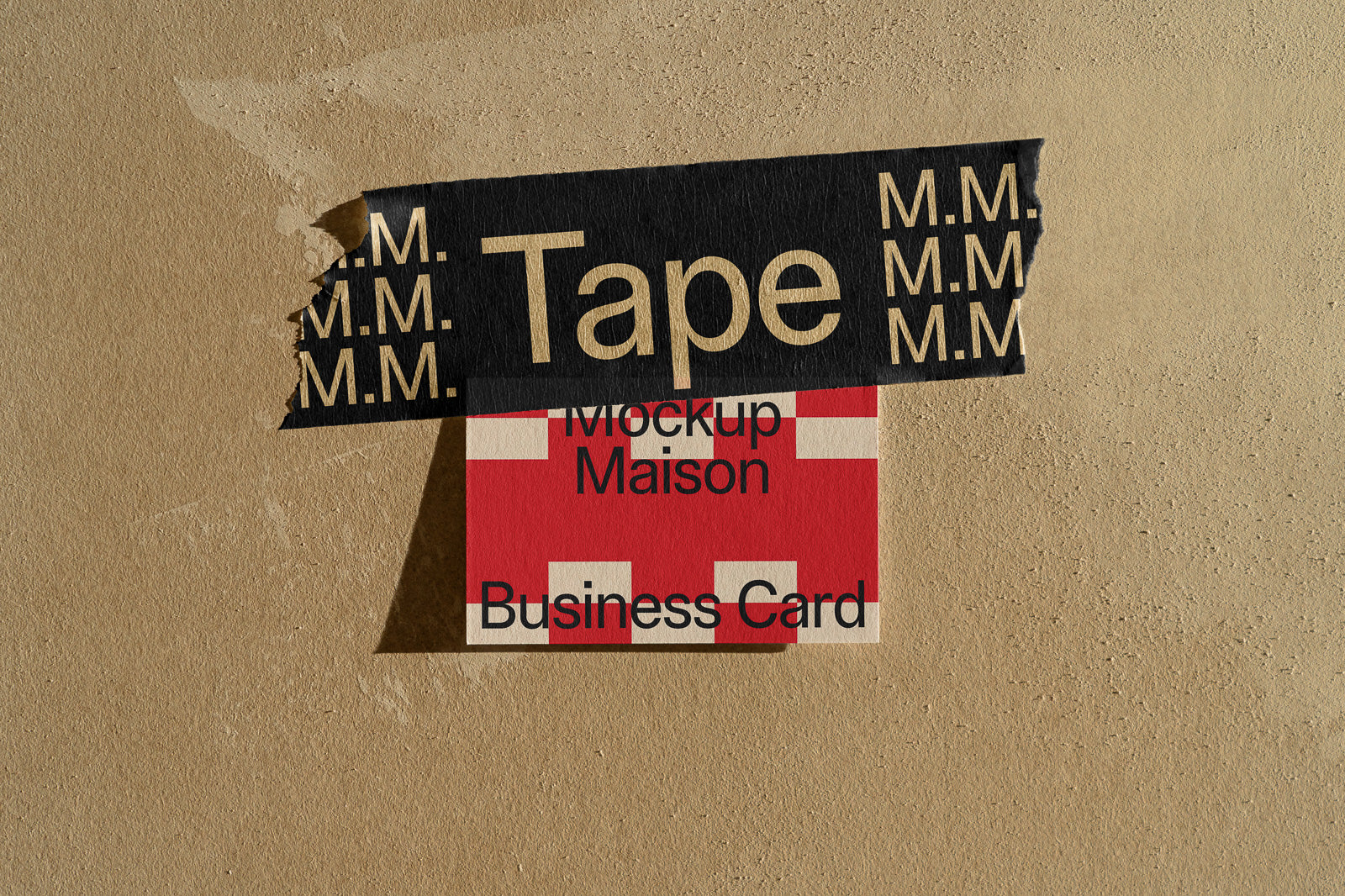 PSD mockup of a business card taped to a textured wall with patterned black tape, displaying a red and beige design with text elements.