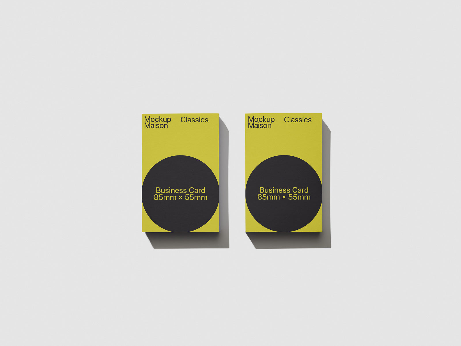 PSD mockup of two business cards on a white background, featuring a yellow design with a black circle and text indicating dimensions 85mm x 55mm.