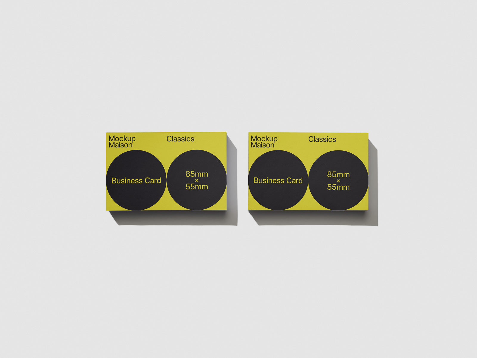 PSD mockup of a yellow business card featuring two black circles, labeled "Mockup Maison" and "Classics" with dimensions 85mm x 55mm on a white background.
