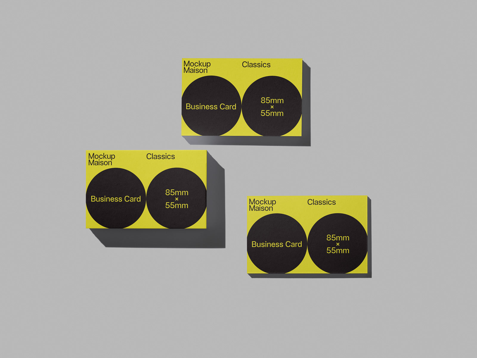PSD mockup of three business card templates in yellow and black with dimensions 85mm x 55mm, titled "Mockup Maison Classics" on a gray background.