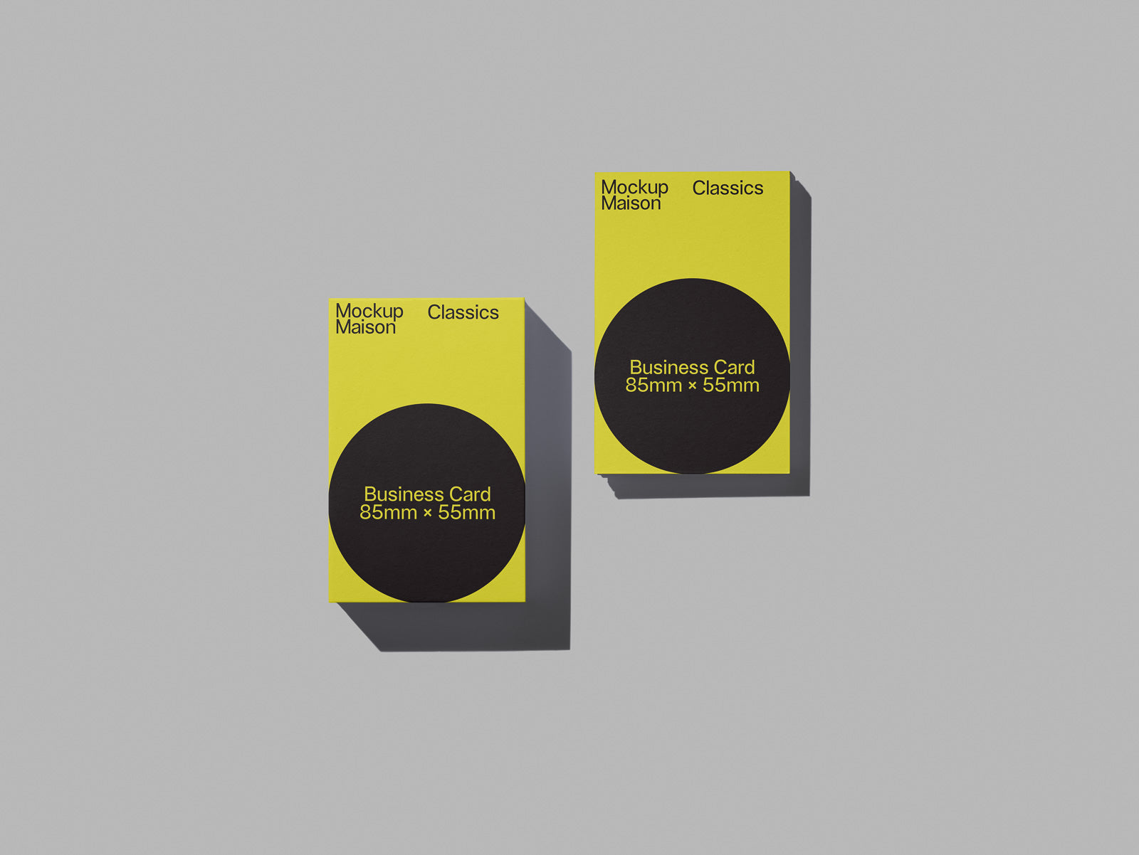 PSD mockup of two yellow business card stacks on a gray background, both labeled with "Mockup Maison Classics" and dimensions 85mm x 55mm.
