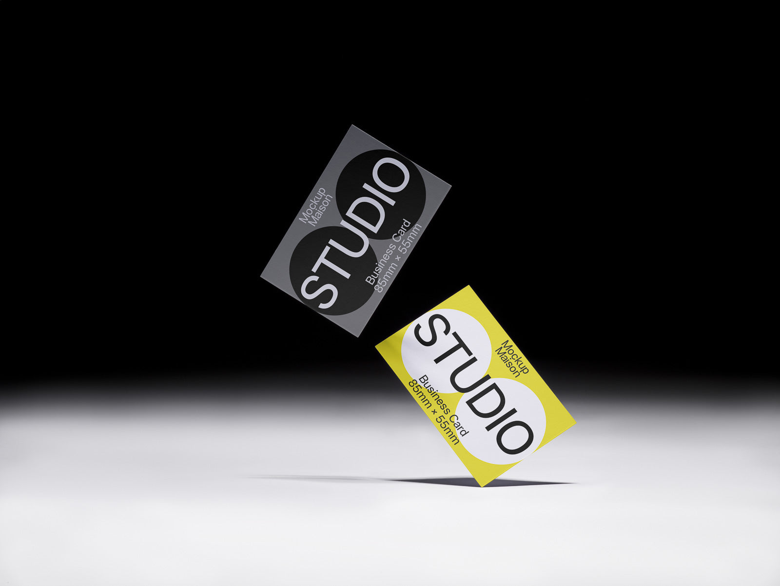 PSD mockup of two business cards, one black and one yellow, floating on a gradient background with shadows, showcasing minimalist design.