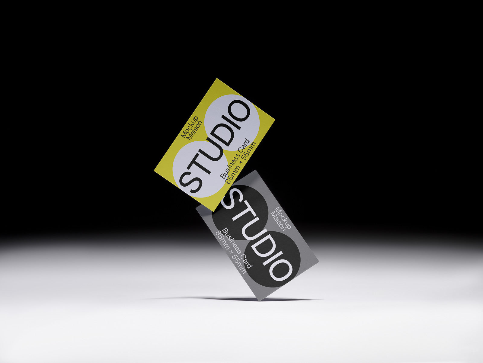 PSD mockup of two stacked business cards, one yellow and one gray, floating against a shadowed ramp background.