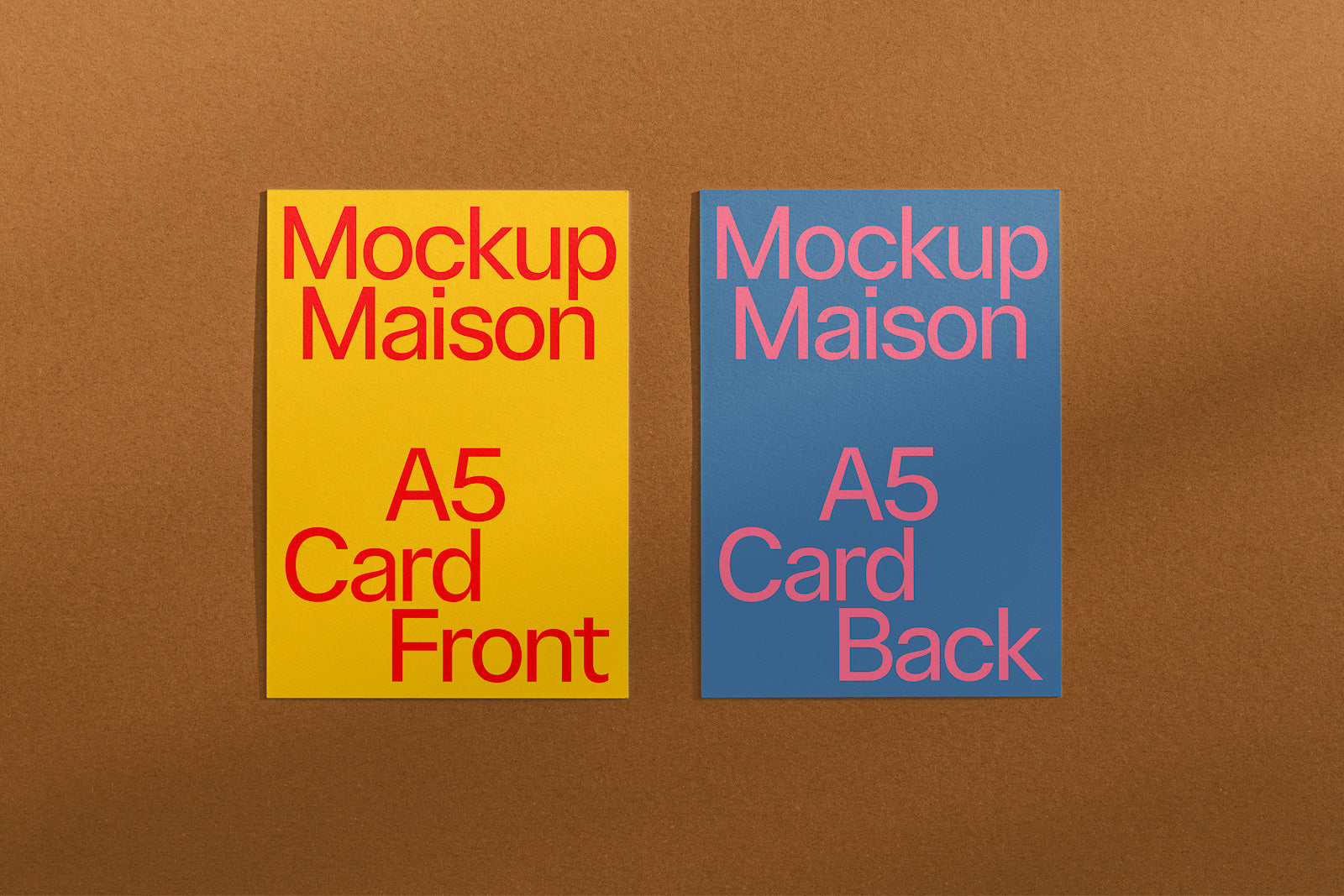 PSD mockup of two A5 cards on a brown background, left card is yellow with red text "Mockup Maison, A5 Card Front," right card is blue with pink text "A5 Card Back."