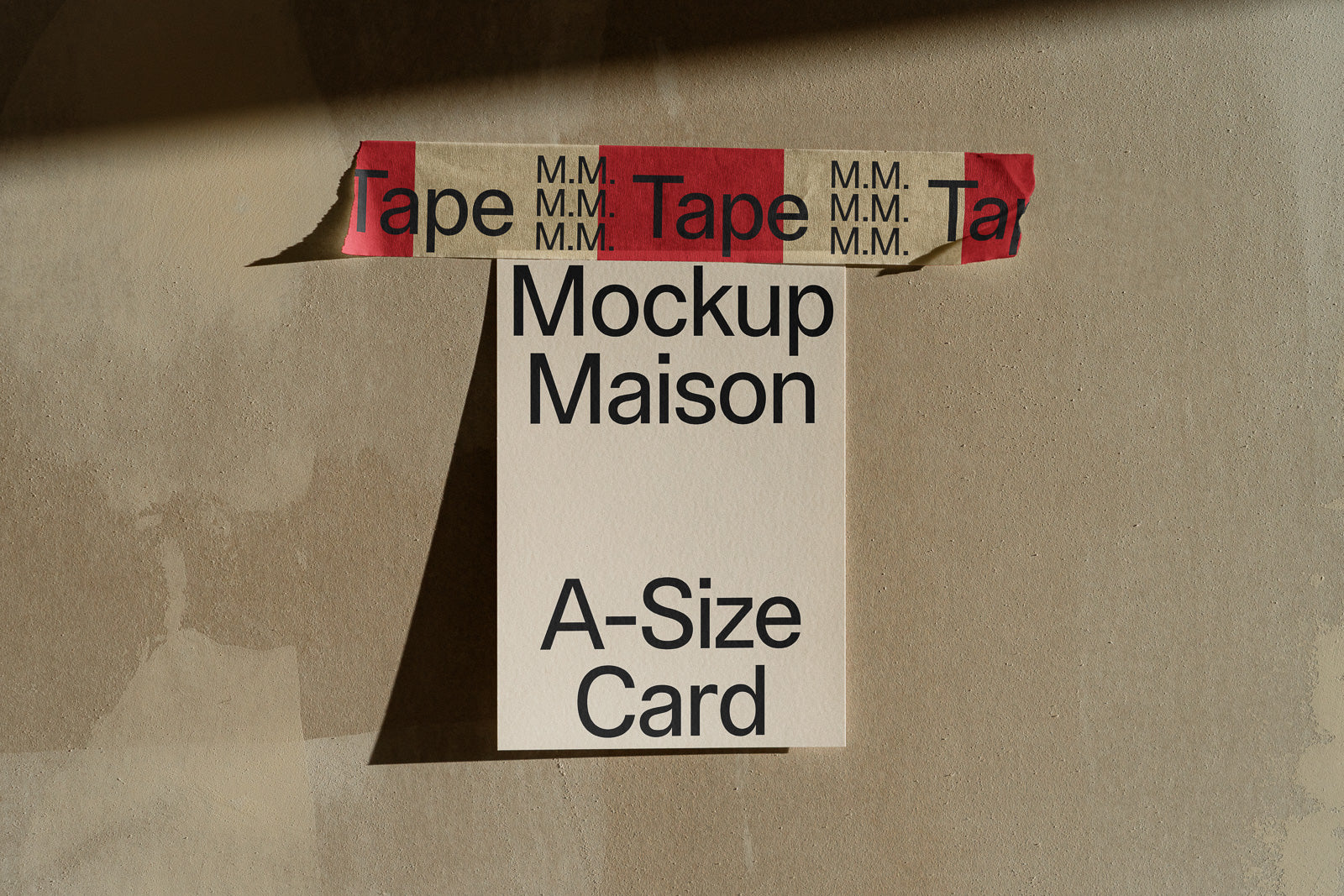 PSD mockup of an A-size card taped to a textured wall with branded tape, casting a shadow to the right.