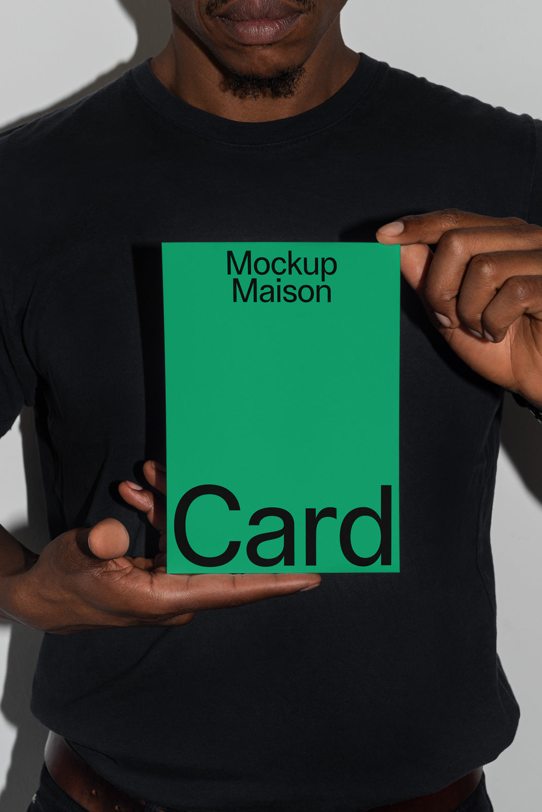 PSD mockup of a person holding a green card with the text "Mockup Maison Card," showcasing design with a subtle shadow effect.