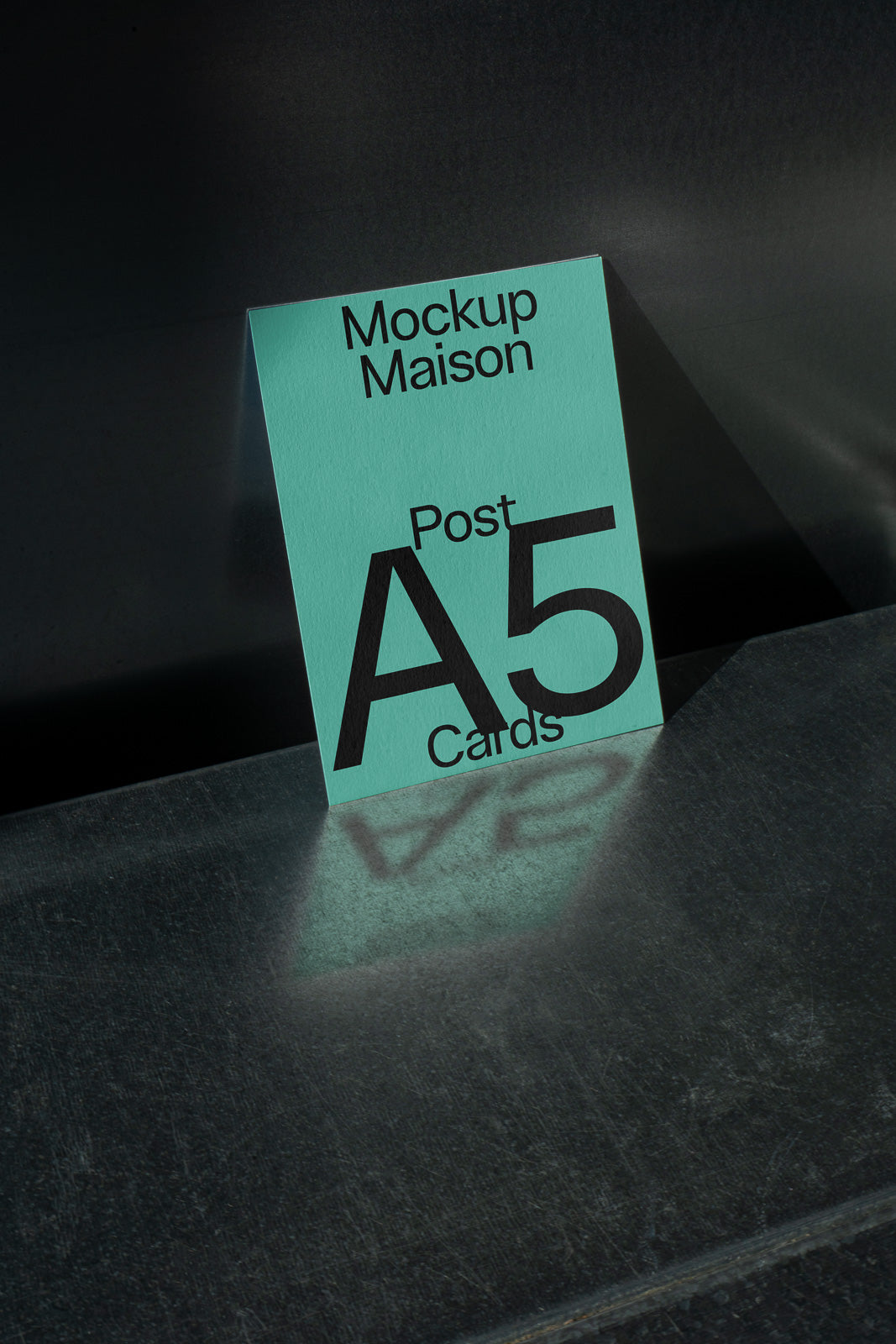 PSD mockup of an A5 card on a reflective surface, featuring the text "Mockup Maison Post A5 Cards" with a shadow effect.
