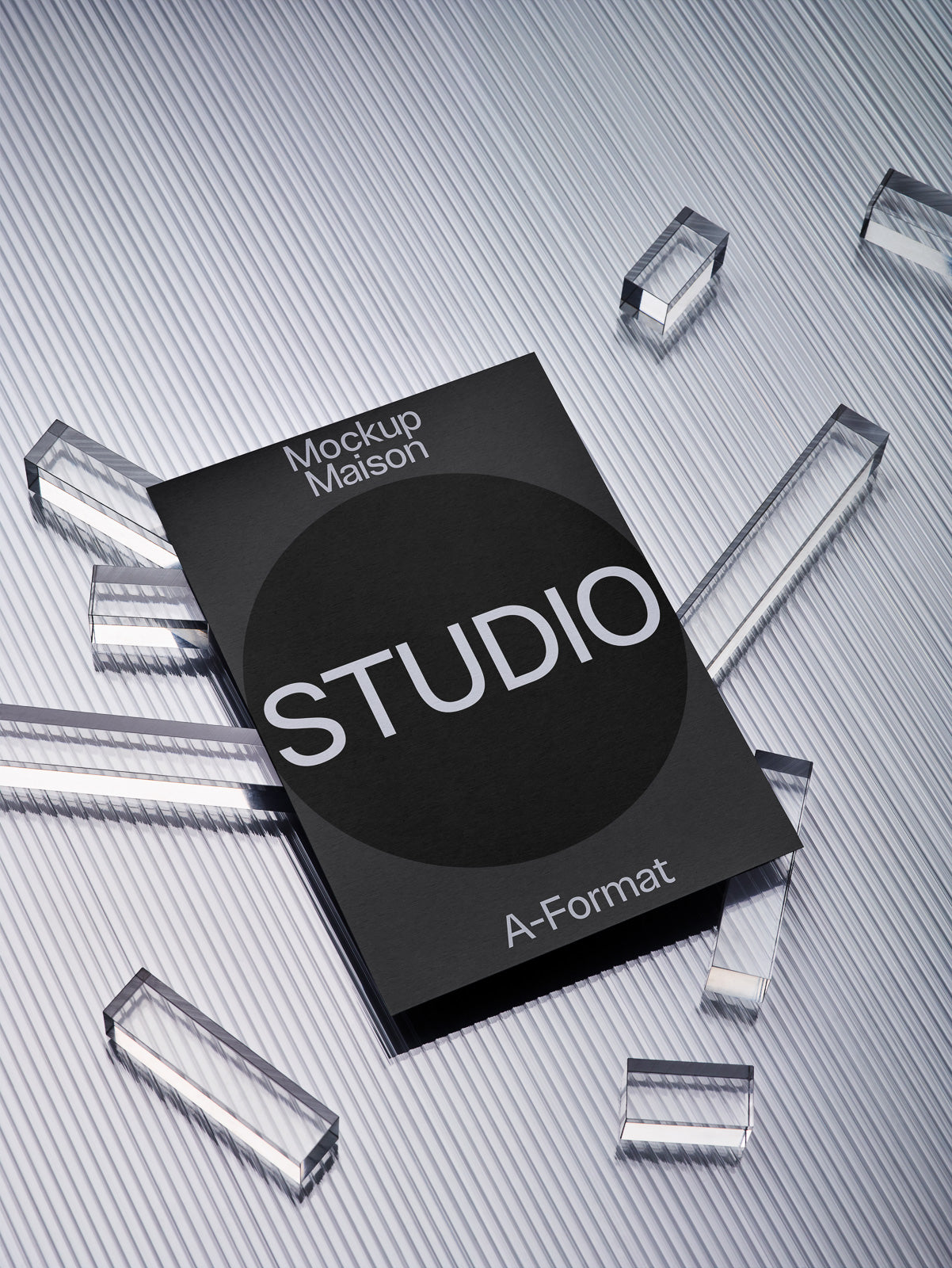 PSD mockup of a black studio-themed booklet labeled "Mockup Maison" and "A-Format" on a textured surface surrounded by clear prismatic shapes.