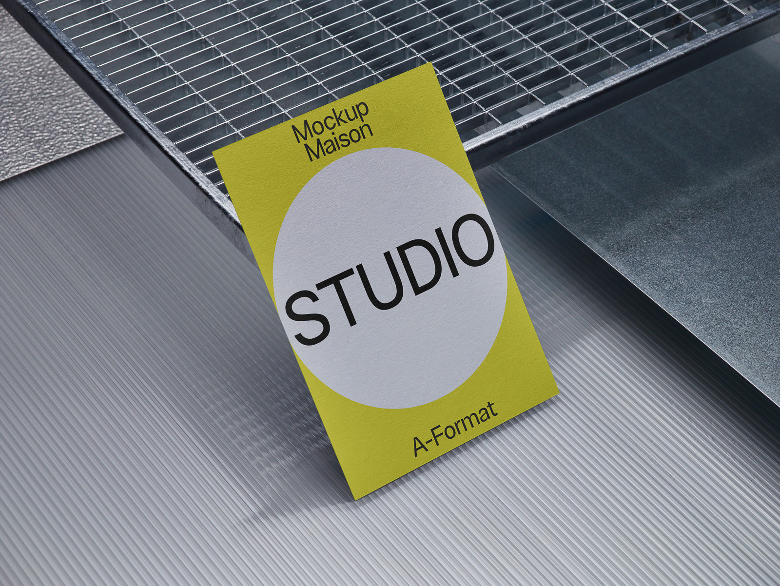 PSD mockup of a yellow card labeled "STUDIO" with grid and metal textures in the background, positioned on a striped surface.