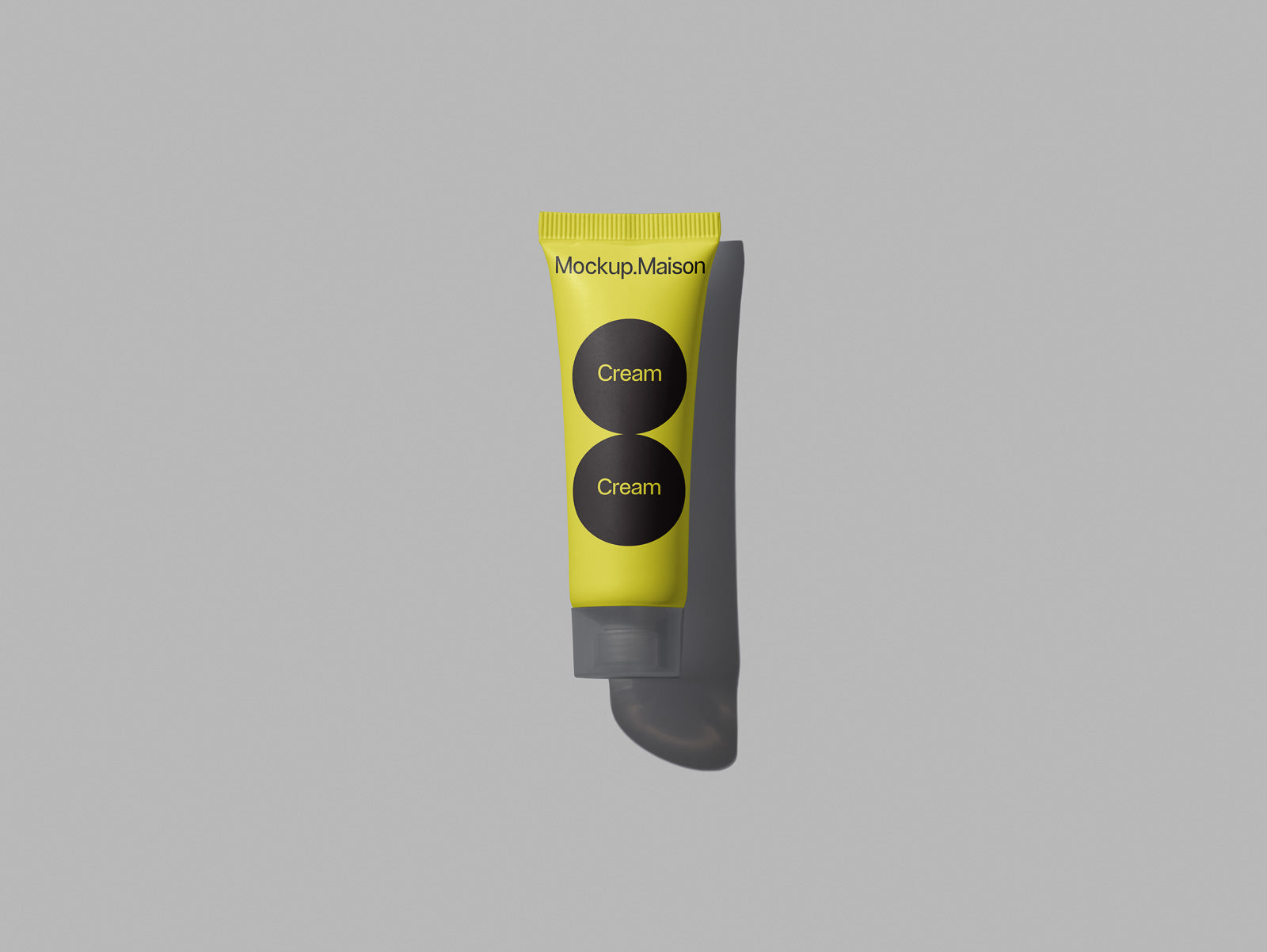PSD mockup of a yellow and black tube labeled "Cream" on a gray background, showcasing minimal branding design with a shadow effect.