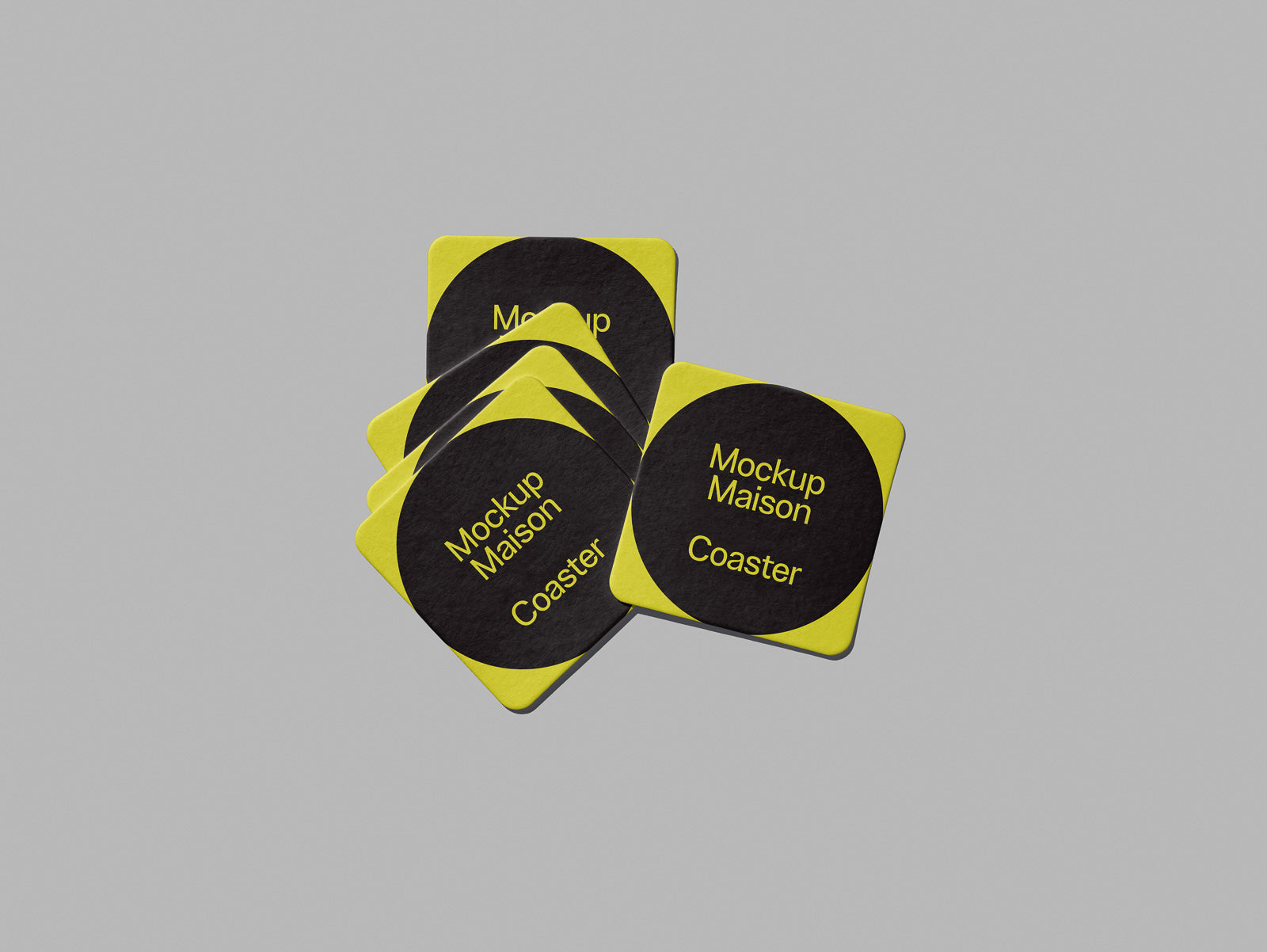 PSD mockup of yellow and black square coasters scattered on a gray background, featuring "Mockup Maison Coaster" text.