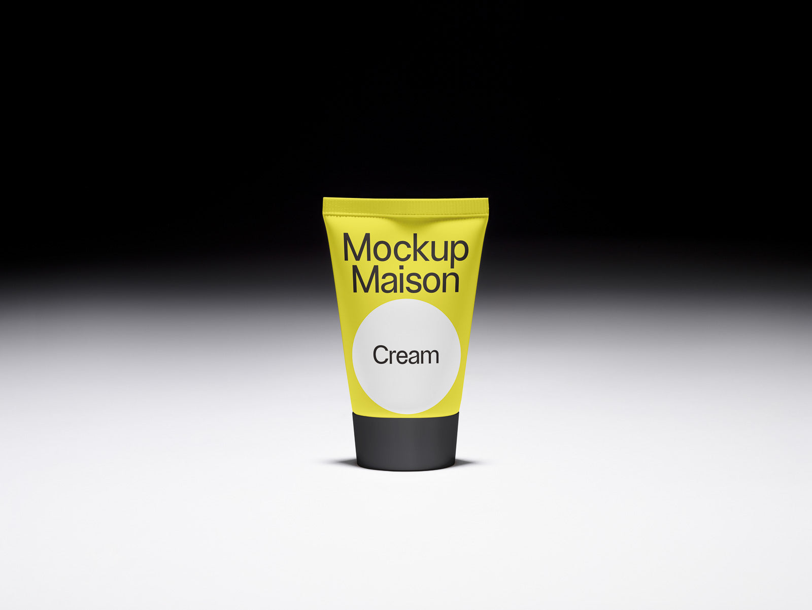 PSD mockup of a yellow cream tube labeled "Mockup Maison" standing upright on a smooth surface with a gradient black to white background.
